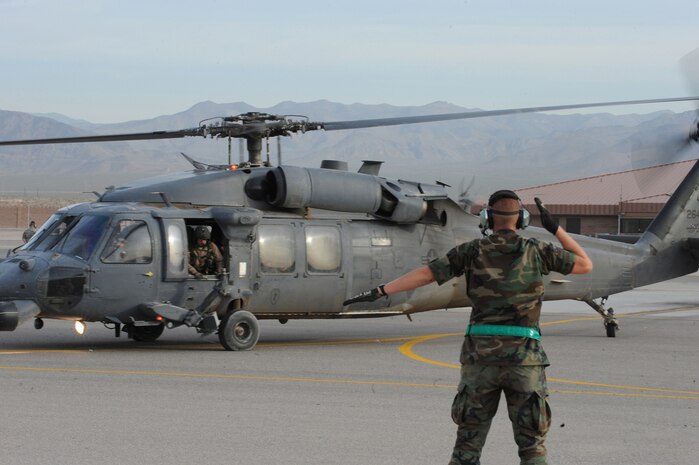 NELLIS AIR FORCE BASE, Nev.- Airman 1st Class Christopher Mallaire, a crew chief with the 763rd Aircraft Maintenance Squadron, prepares to taxis out an HH-60G Pavehawk helicopter departing for a real-world rescue mission May 1. Four helicopters and approximately six personnel from the 58th and 66th Rescue
Squadrons deployed to assist in the search for a pilot and passenger who
were aboard a motorized sailplane that disappeared from radar in the Sierra
Nevada Mountain Range near Mammoth Lakes, Calif., April. 24.  The aircraft
was flying between Tonopah, Nev., and Modesto, Calif., and a search began
about an hour after the plane was overdue.  The Air Force Rescue
Coordination Center is overseeing the effort and as of April 30, the Civil
Air Patrol and other agencies had flown more than 140 sorties in a 2,500
square-mile search area.

(U.S. Air Force photo by/Senior Airman Nadine Y. Barclay)