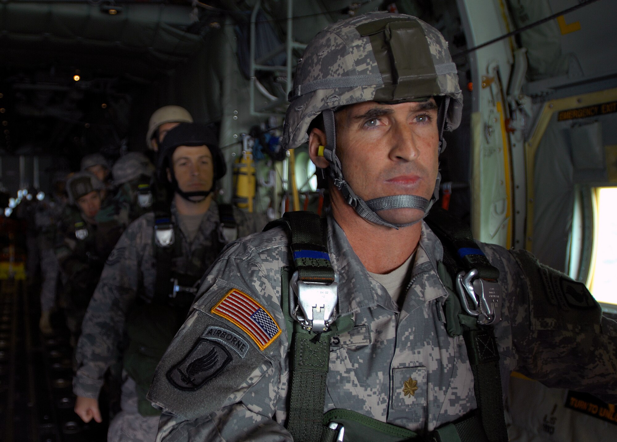 An Army partrooper peers out the back of a new C-130J Super Hercules before jumping during the first Ramstein Air Base, Germany, C-130J personnel drop over southern Germany May 4. (U.S. Air Force photo/Senior Airman Kenny Holston) 
