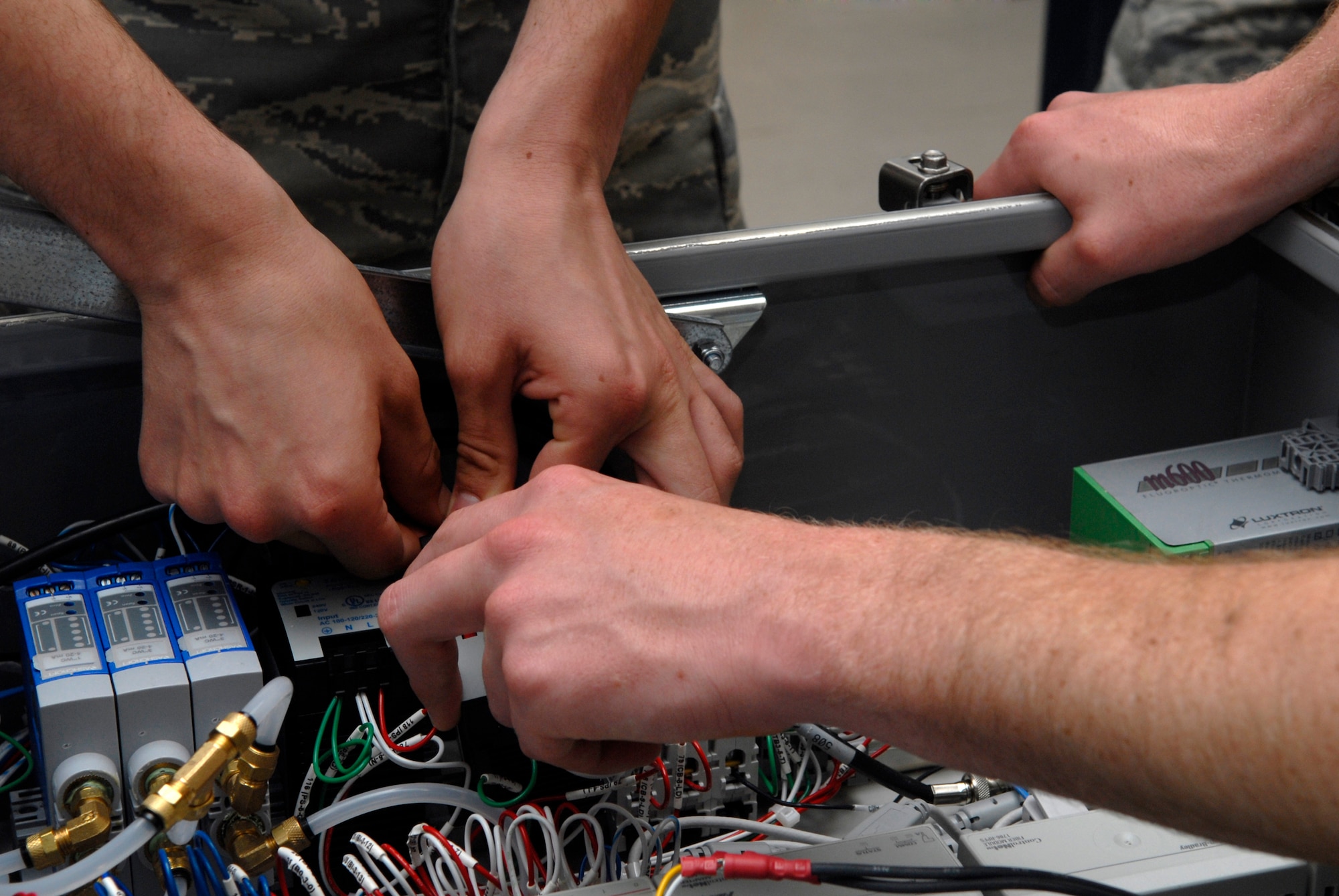 VANDENBERG AIR FORCE BASE, Calif. -- 532nd Training Squadron students troubleshoot a new environmental control system for the missile facilities here May 5. The missile and space systems facilities course provides students the skills and knowledge needed to maintain and operate launch facility and missile alert facility diesel-electrical and electrical power systems, support vehicles, refrigeration and environmental control systems, and waste disposal systems. (U.S. Air Force photo/Senior Airman Christian Thomas)