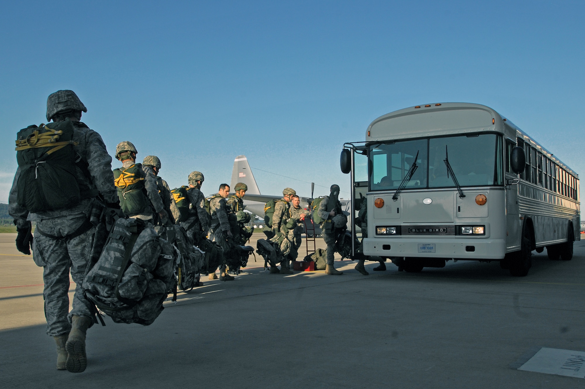 Airmen and Army paratroopers load a troop bus in preparation for the first C-130J Super Hercules personnel drop May 4 at Ramstein Air Base, Germany. (U.S. Air Force photo/Senior Airman Kenny Holston) 
