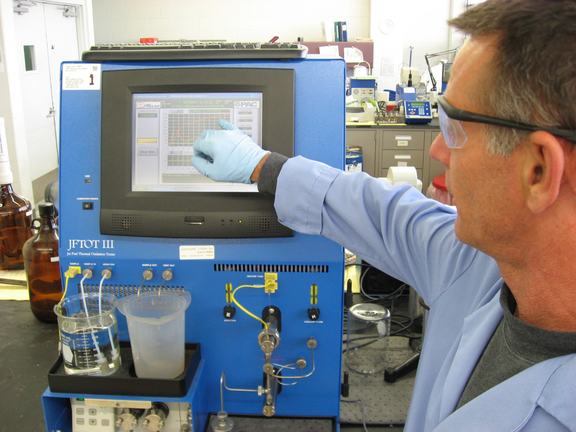 Mike Thiede uses a jet fuel thermal oxidation tester to test samples of commercial Jet A fuel in a lab at Wright-Patterson Air Force Base, Ohio. Air Force Petroleum Agency researchers have launched an initiative to evaluate the use of commercial jet fuel in place of military standard JP-8 fuel. Mr. Thiede is a a fuels quality assurance specialist with the Aerospace Fuels Laboratory at Wright-Patterson AFB. (U.S. Air Force photo/Derek Kaufman)