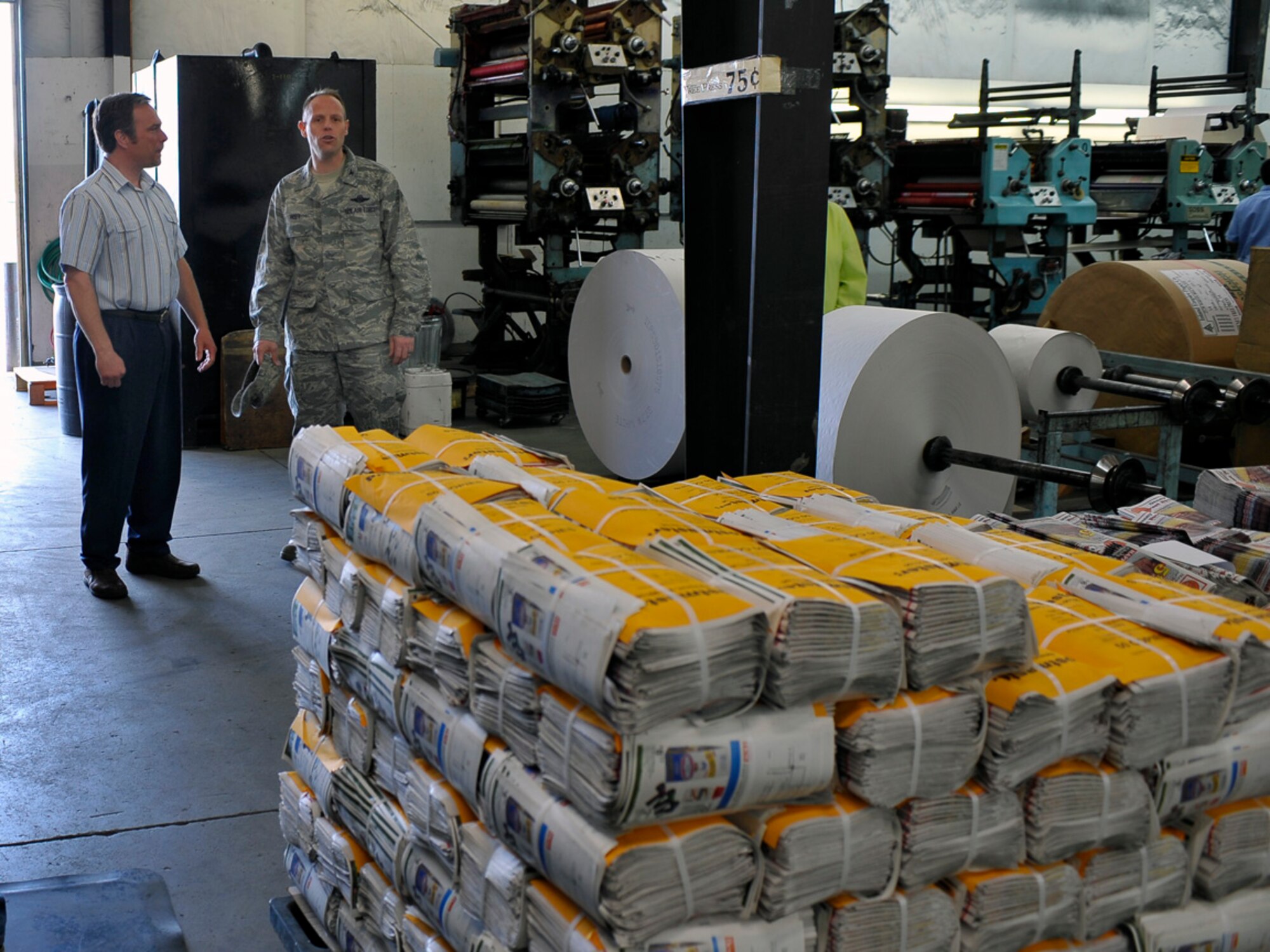 Harland Shellabarger, Cheney Free Press publisher, stops at the printing room while giving Col. Blaine Holt, 92nd Air Refueling Wing vice commander, a tour of the Cheney Free Press headquarters May 4. The base has officially switched from the e-Connection, Fairchild’s online news service, to a hard-copy newspaper that will circulate throughout the Fairchild community. (U.S. Air Force photo / Airman 1st Class Melissa L. Carlino)