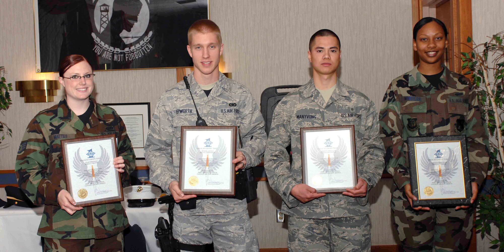 CANNON AIR FORCE BASE, N.M. -- (Left to right) Staff Sgt. Jessica Mattes, 27th Special Operations Civil Engineer Squadron, Senior Airman Billy Hepworth, 27th Special Operations Security Forces Squadron, Airman 1st Class Thomas Manyvong, 27th Special Operations Medical Support Squadron and Airman 1st Class Jessica Wheeler, 27th Special Force Support Squadron, display their Diamond Sharp awards at the Pecos Trail Dining Facility May 8. Diamond Sharp awards are presented monthly to Airmen who display excellence on and off duty. (U.S. Air Force photo/Airman 1st Class James Bell)