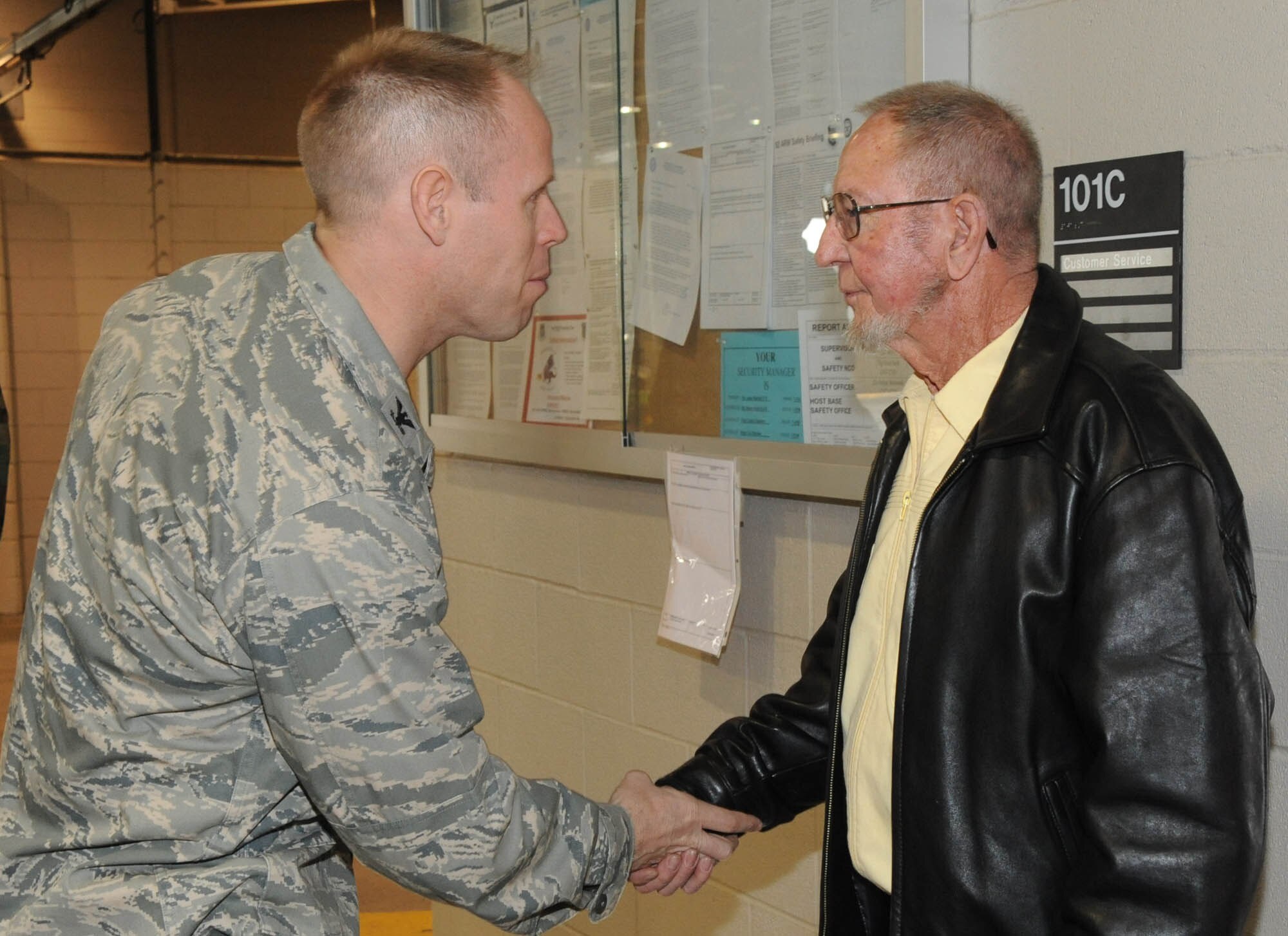 Col Blaine Holt, 92 Air Refueling Wing vice commander, coins Charles “Tom” Gooch, 92 Logistics Readiness Squadron, for his 53 years of service on April 30 at his retirement ceremony. April 30. (U.S. Air Force photo / Staff Sgt. JT May III)