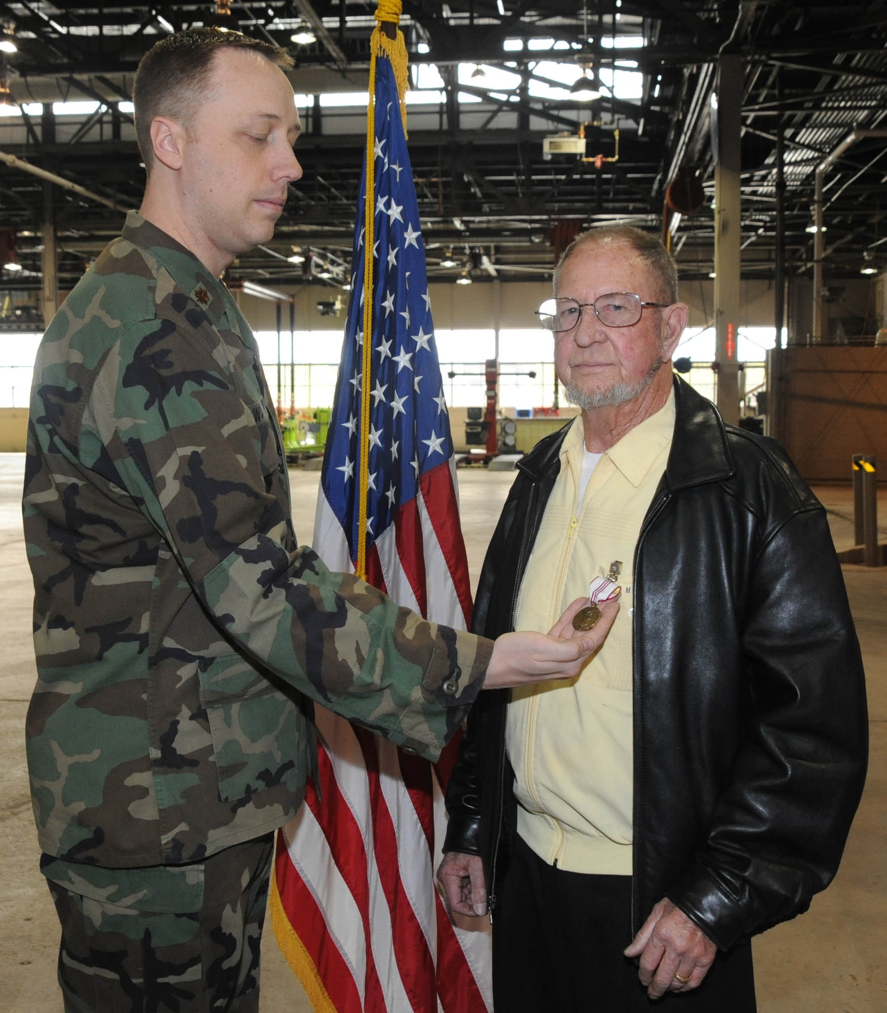 Charles “Tom” Gooch, 92nd Logistic Readiness Squadron heavy equipment mechanic, receives his Outstanding Civilian Career Service Award from Maj. Breck Woodard, 92nd LRS commander. The retirement ceremony was held on April 30 at the Vehicle maintenance building 2045.  Mr. Gooch served twenty years in the military including a tour in the Korean and Vietnam War. Mr. Gooch went on to serve 34 years civil service and worked many different positions during his military and civilian time such as aircraft loader and corrosion control. While working at the 92nd LRS his dedication to duty were reflected in many ways. His actions greatly contributed to outstanding and excellent ratings from Logistics Standardization and Evaluation Program and Unit Compliance Inspection. Mr. Gooch said, “Its been fun and I have no regrets, but I think its time to kickback and relax.” Mr. Gooch is moving to Tucson, Ariz., and going to spend his time traveling with his wife Linda. (U.S. Air Force photo / Staff Sgt. JT May III)