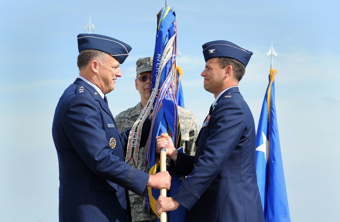 LANGLEY AIR FORCE BASE, Va. --  Col. Matthew H. Molloy assumes command of the 1st Fighter Wing by accepting the guidon from Lt. Gen. Gary L. North, commander of the 9th Air Force and U.S. Air Forces Central, during the change of command ceremony here May 8. Colonel Molloy assumed command from Brig. Gen. Mark A. Barrett. (U.S. Air Force photo/Airman 1st Class Gul Crockett)