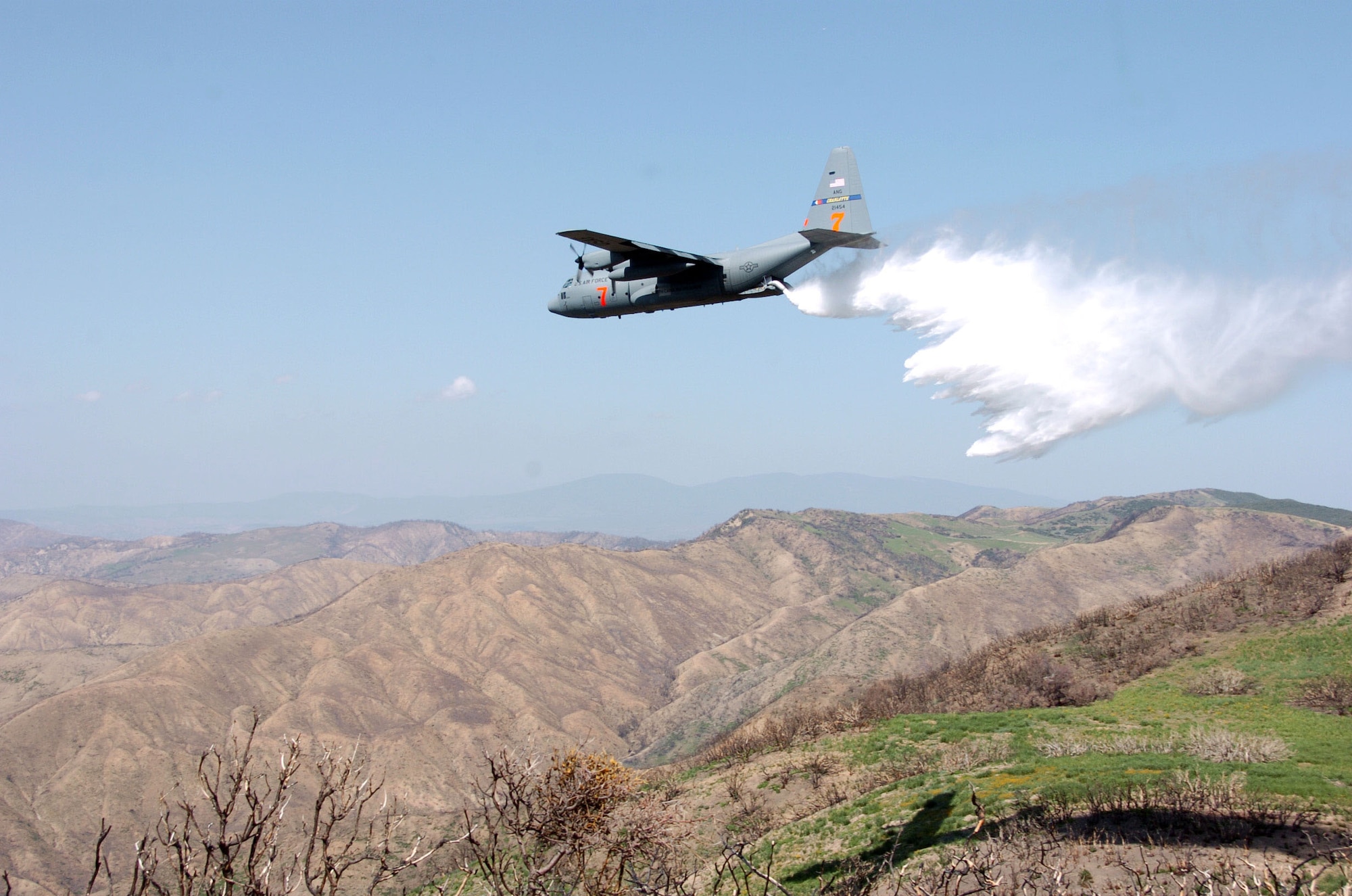 A C-130 Hercules cargo plane assigned to the 145th Airlift Wing, North
Carolina Air National Guard, drops 3,000 gallons of water using Modular
Airborne Fire Fighting System (MAFFS) during the MAFFS 2008 annual
certifying event. The annual training event includes all aircrew,
maintenance, support personnel directly supporting the MAFFS mission. There
are 4 Air National Guard and Air Force Reserve units involved with MAFFS:
145th Airlift Wing, (Charlotte), 146th Airlift Wing (Channel Islands), 153rd
Airlift Wing, (Wyoming) and the 302nd Airlift Wing (Colorado). Photo By Tech
Sgt Brian E. Christiansen, N.C. Air National Guard Public Affairs.
