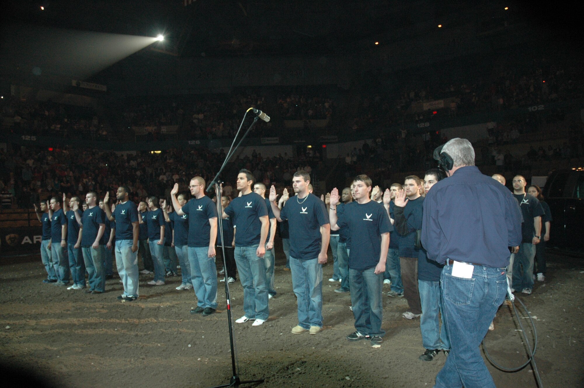 Sixty members of the delayed entry program from the New England states take the oath of enlistment provided by Lt. Col. Jeffrey Keckley in the center ring of the Air Force Invitational Professional Bull Riders show May 2 in Worcester, Ma. Colonel Keckley is the commander of the 319th Recruiting Squadron. The Air Force sponsorship of PBR provides the chance to share information and job opportunities with millions of fans. (U.S. Air Force photo/Tech. Sgt. Michael Brown)