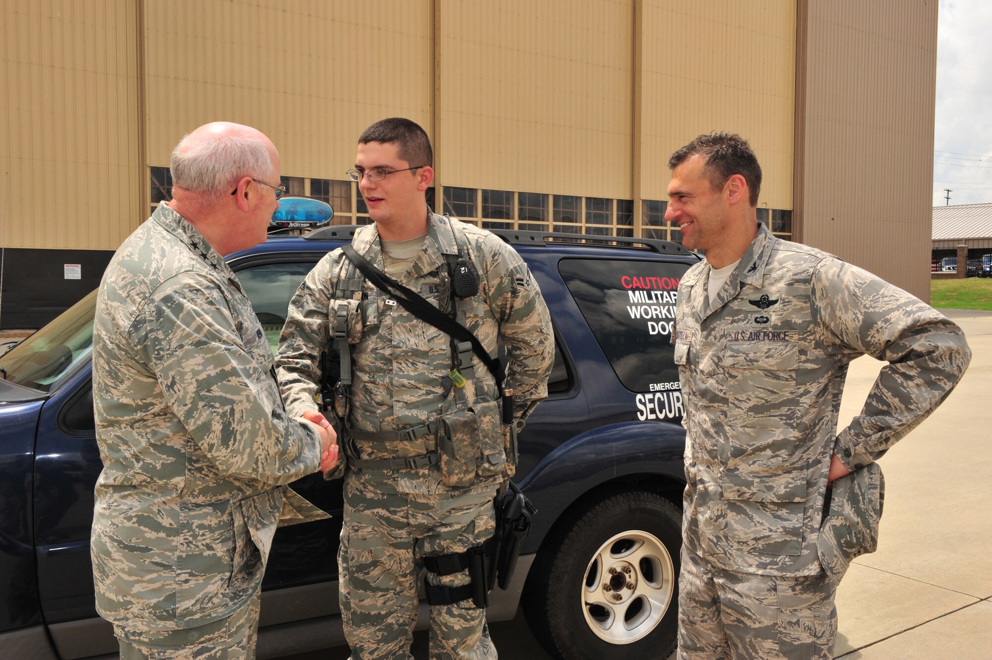 Shaw Air Force Base, S.C.- Lieutenant General Loren Reno, Deputy Chief of Staff for Logistics, coins Airman First Class Jason Clarkson, 20th Security Forces Squadron, while Colonel Joseph Guastella, 20th Fighter Wing Commander,  witnesses, May 6, 2009.  LtGen Reno spent most of the day touring Shaw AFB, learning how each duty section was making improvements using AFSO 21 and hearing the thoughts of the Airmen who work at Shaw.  (U.S. Air Force Photo by Senior Airman William Coleman)