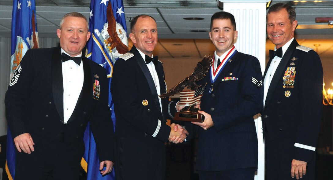 Senior Airman Jason Weigl, 779th Medical Support Squadron biomedical equipment technician, accepts the 2008 Air Force District of Washington Airman of the Year (co-winner award) from Maj. Gen. Ralph Jodice, AFDW commander, as Gen. William Fraser, Vice Chief of Staff of the Air Force, and Chief Master Sgt. Paul Wheeler, AFDW command chief, observe during the AFDW Annual Awards at the Bolling Club on Bolling Air Force Base May 1. The yearly ceremony acknowledges the outstanding achievements of Airman and civilian personnel assigned to the Air Force District of Washington. (U.S. Air Force photo/ Senior Airman Sean Adams)