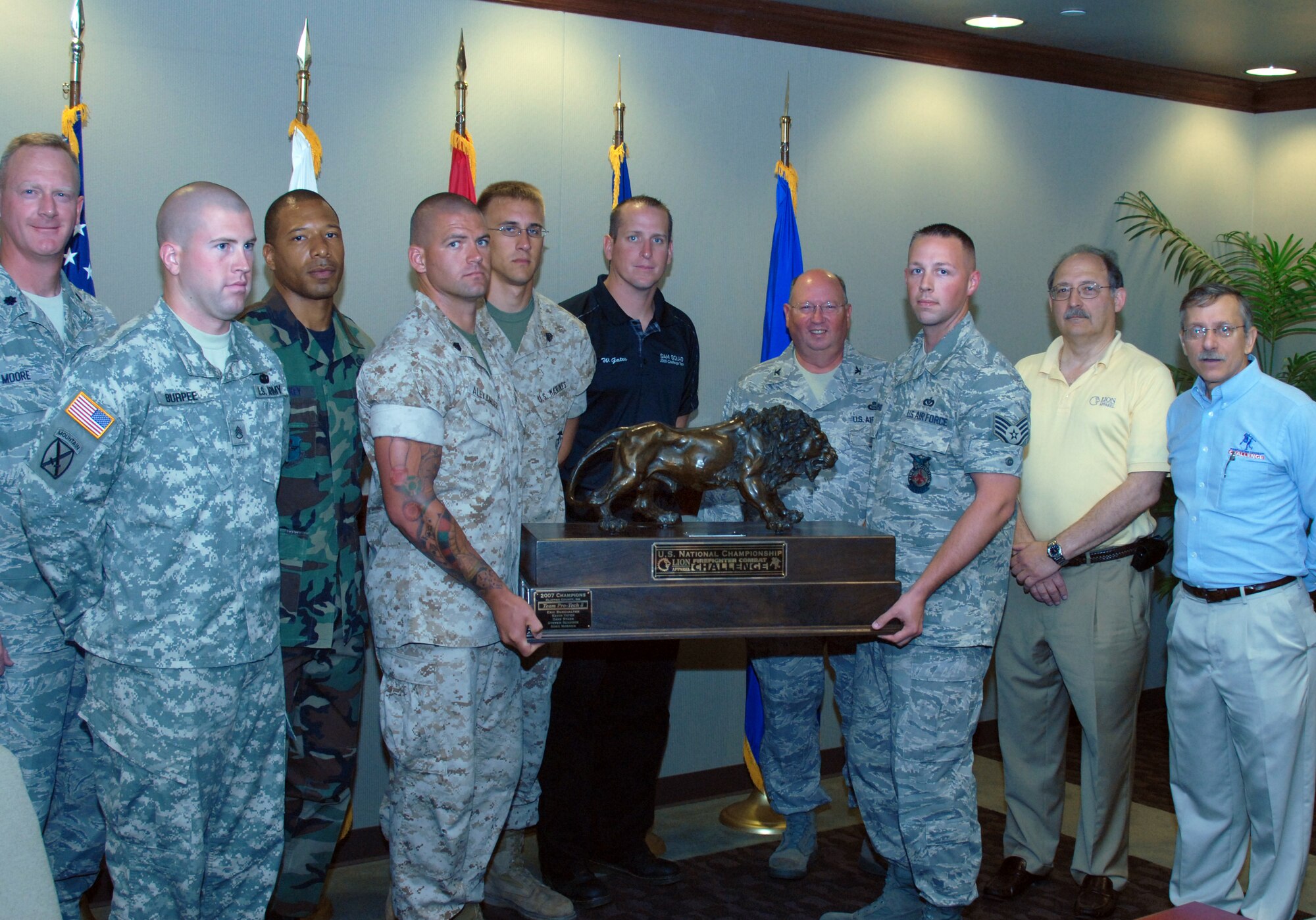 Col. Richard Ayres, 17th Training Wing commander, Goodfellow Air Force Base, Texas (center/back), Lt Col. Moore, 312th Training Squadron commander (far left), John Granby, Lion Apparel and Dr. Paul O. Davis, Ph.D., President, On Target Challenge Inc. (far right) present the 2008 National Championship Firefighter Combat Challenge Trophy to this year’s current Goodfellow SAM Squad.  From left to right:  Army Staff Sgt. Stephen Burpee, Air Force Master Sgt, Thadius Sankey, Marine Sgt. William Alexander, Marine Sgt. Talan Wyenandt, Mr. William Gates, Air Force Staff Sgt. Kevin Wasiewski, and not in pictured Marine Staff Sgt. Christopher Pickett.  The winners of the 2008 Grand NCFCC in both relay and team were:  Marine Staff Sgt. Charles Ammon who is not pictured and currently assigned to Camp Pendleton Marine Corps Air Stations, Cali., Marine Staff Sgt. Nicholas Cook not pictured and currently assigned to Yuma MCAS, Ariz., Sgt. Alexander, Staff Sgt. Wasiewski, and Staff Sgt. Gates.  Dubbed “the toughest two minutes in sports” by ESPN, the Challenge simulates the physical demands of real-life firefighting as competitors race against themselves, their opponent and the clock, wearing "full bunker gear" and their Air-Pak breathing apparatus, to tackle a linked series of five tasks including a 5-story tower, hoisting, chopping, dragging hoses and rescuing a life-sized, 175 lb. “victim.”   The SAM Squad team finished second in the 2008 World Challenge, missing the top spot by 1.4 seconds.  (U.S. Air Force photo by Senior Master Sgt. Robert Martinez)