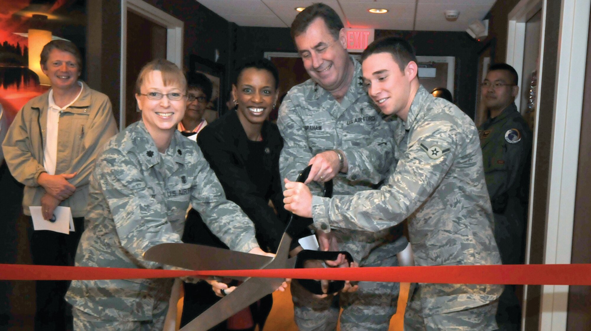Lt. Col. Kathryn Tate, 779th Medical Surgical Squadron commander, Congresswoman Donna Edwards, Maj. Gen. Gar Graham, 79th Medical Wing commander and Airman Joseph Metcalf, 779 MSGS opthamology technician, cut the ribbon for the grand opening of the Warrior Eye Center at Malcolm Grow Medical Center May 1. The center will provide corrective eye surgery for Active Duty military members. (U.S. Air Force photo/ Tech. Sgt. Suzanne M. Day)