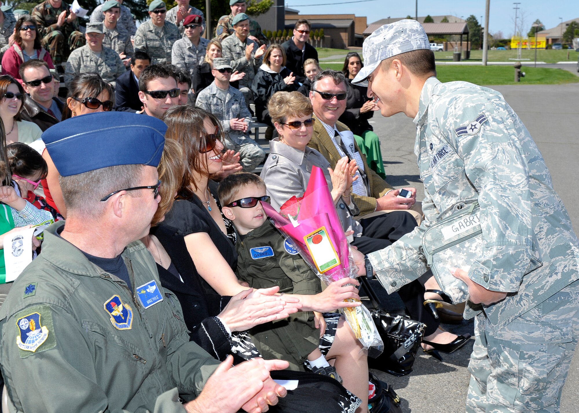 Lt. Col. Christopher Tacheny’s wife, Sandra, is given flowers by an Airman from the 336th Training Group during the 66th Training Squadron’s Change of Command Ceremony here May 1. Colonel Tacheny took command of the unit. (U.S. Air Force photo / Senior Airman Joshua K. Chapman)