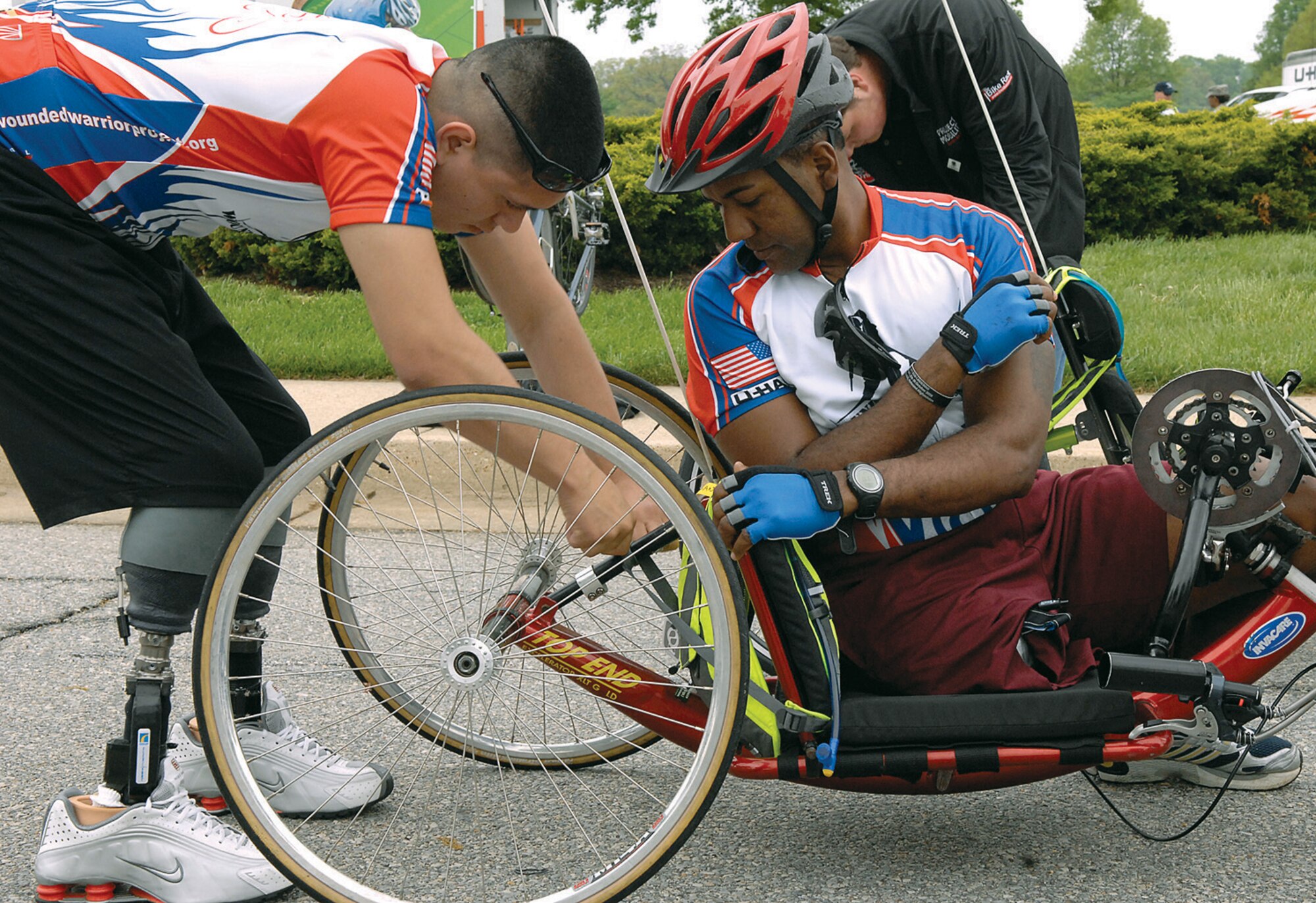 Lance Corporal Jose Casca, an infantryman from the 3rd Battalion 6th Marine Division, helps Sgt. Alfredo Delossantos, a Civil Affair Specialist from the 98th Army Civil Affair Battalion, with his vehicle prior to the start of the Soldier Ride in front of the 316th Wing Headquarters, Bldg. 1535, May 1. The wounded warriors rode from Andrews to Annapolis, Md. as part of a two-day event to raise awareness of issues that veterans are challenged with when they return wounded from combat. (U.S. Air Force photo/ Senior Airman Giang Nguyen)