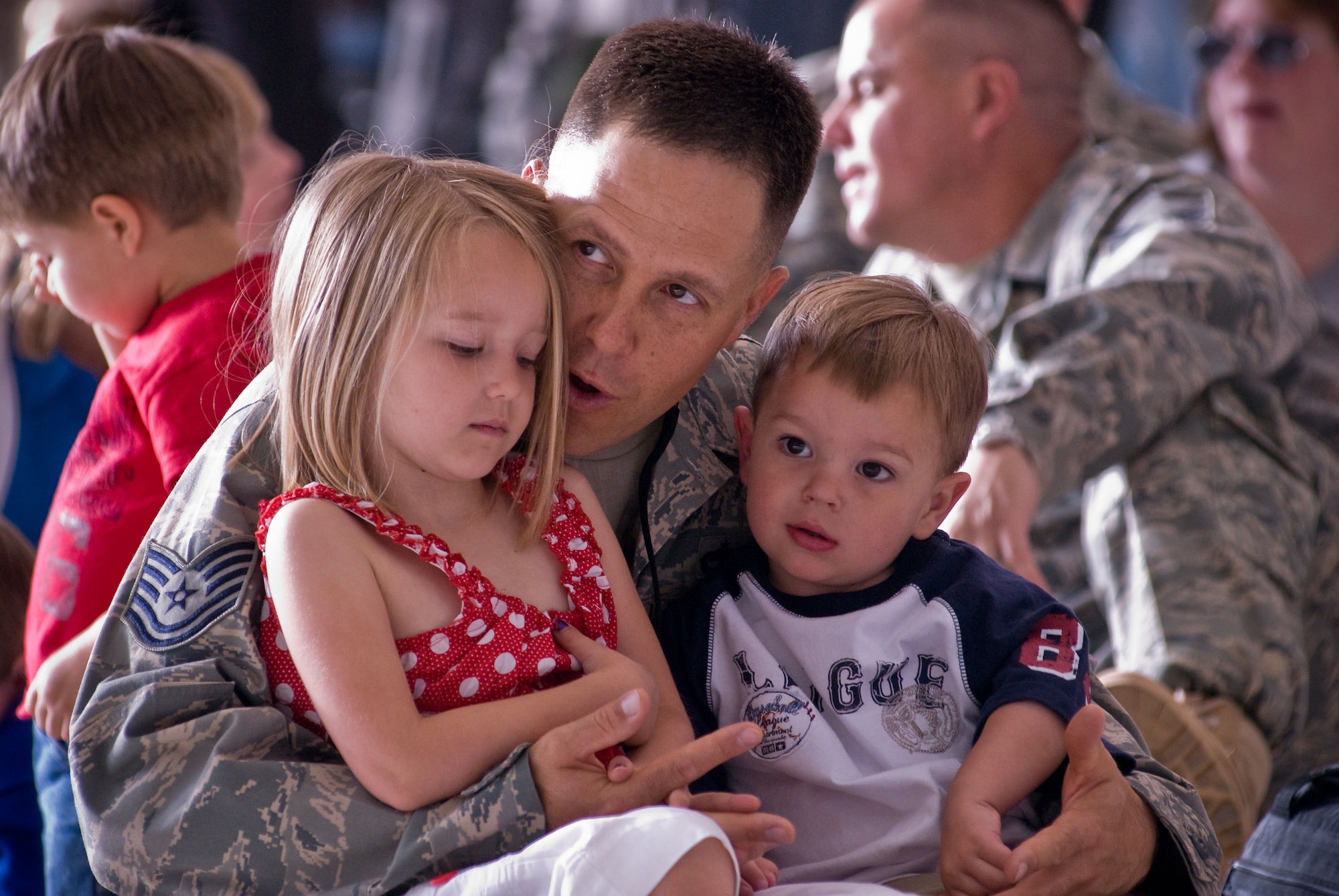 Technical Sgt. William Schmidt, 140th Aircraft Maintenance Squadron, Colorado Air National Guard, Buckley Air Force Base, Aurora Colorado, talks with his daughter Shealie and son Rylan as he waits to hear his name called just prior to deploying to Iraq. (U.S. Air Force photo/Master Sgt. John Nimmo, Sr.) (RELEASED)