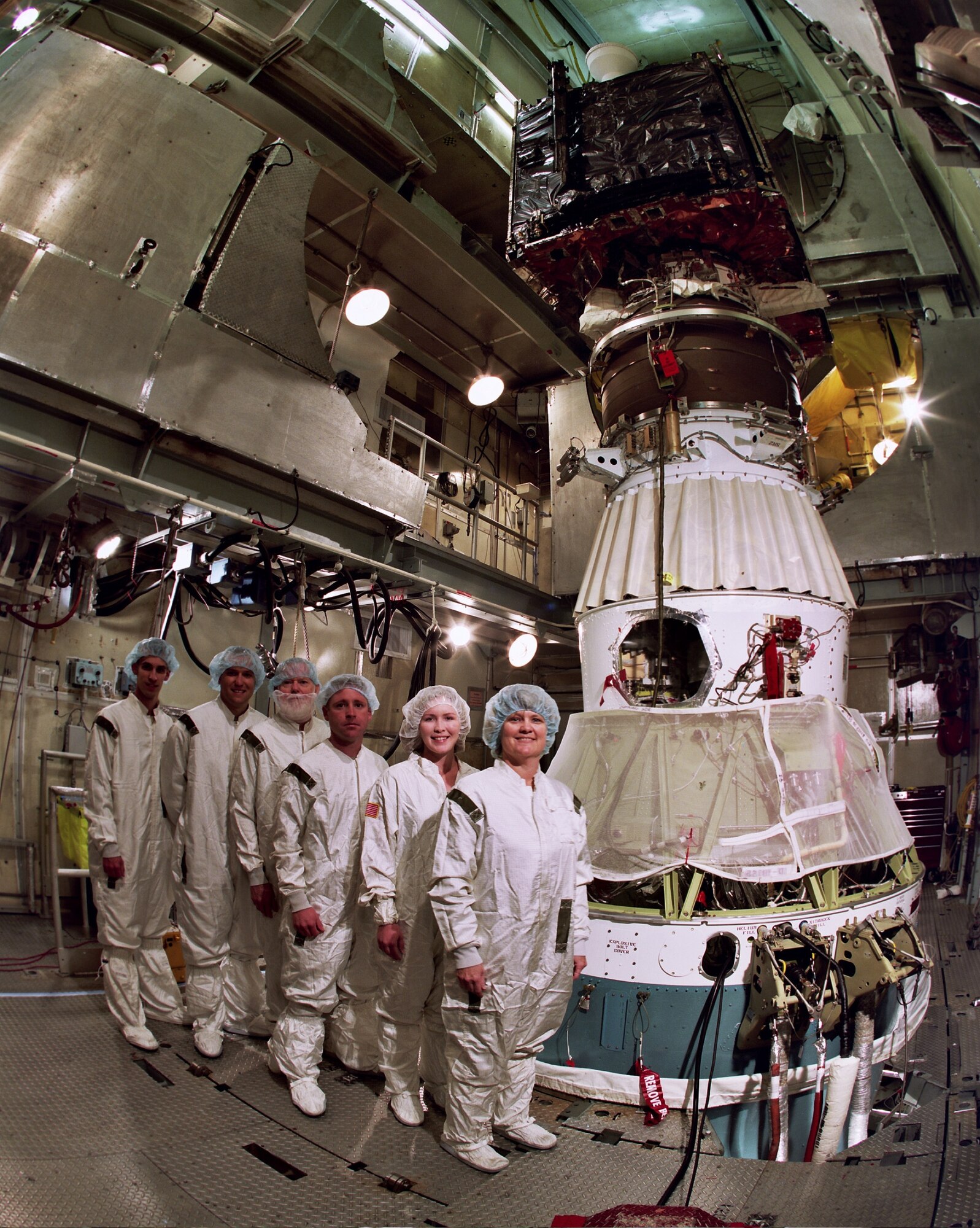 Members of the 45th Launch Support Squadron, along with the 45th Range Management Squadron's GPS team, pause in front of the GPS IIR-20 satellite atop its Detla II booster prior to its launch March 24. (Lockheed Martin photo/Bruce Johnson)