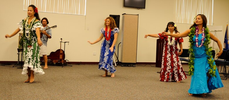 (left to right) Amber Armstrong, Senior Airman Christina McCann, Julie Carrigan and Maj. Janice Hance do a traditional hula dance as Justin Alderfer provides musical accompaniment at the Taste of Asia luncheon May 1 at the Shark Center that kicked off Asian Pacific American Heritage Month at Patrick Air Force Base. (U.S. Air Force photo/John Connell)