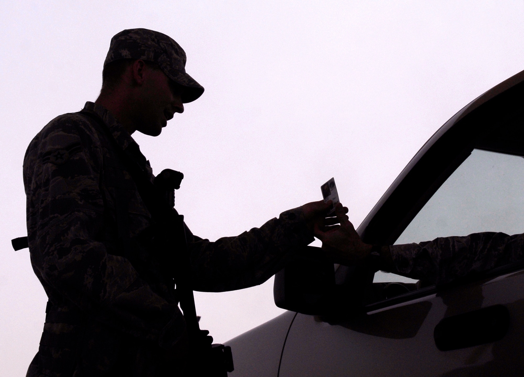 Airman 1st Class David Foss, 379th Expeditionary Security Force Squadron Member, checks the ID card of an individual coming through the Coalition Compound entry control point, May 7, 2009, at an undisclosed location in Southwest Asia.  The Coalition Compound entry control point houses a new substation which aids security forces in expediting reports more efficiently.  Airman Foss hails from Fruitland, Idaho and is deployed from Keesler Air Force Base, Miss., in support of Operations Iraqi and Enduring Freedom and Combined Joint Task Force - Horn of Africa.  (U.S. Air Force photo/Senior Airman Andrew Satran/released)