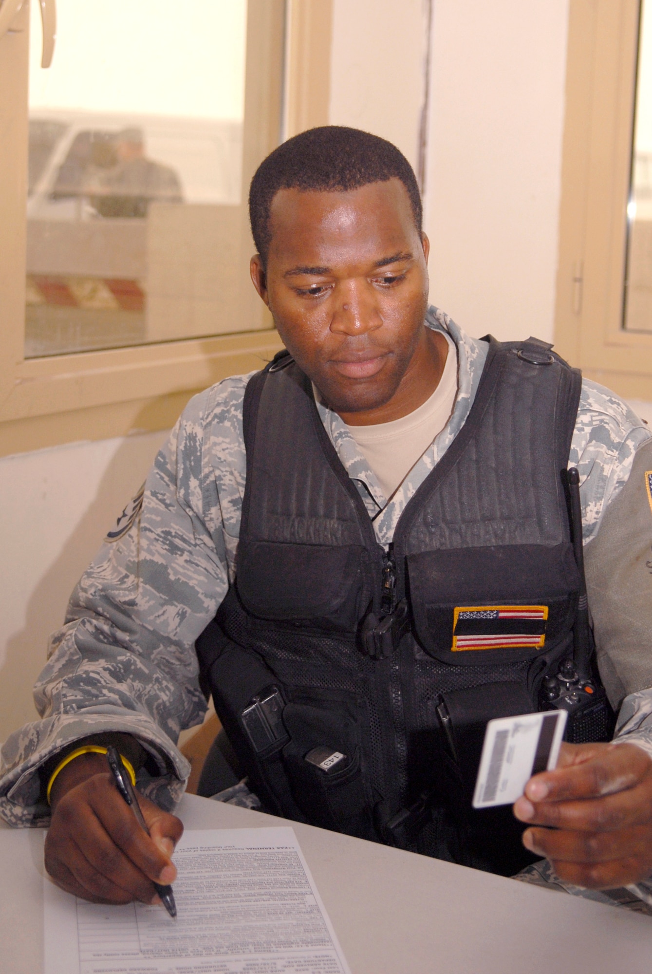 Staff Sgt. Fitzporter Kidd, 379th Expeditionary Security Forces Squadron fire team leader, checks a lost ID card that was turned in at the new entry control point substation, May 7, 2009, at an undisclosed location in Southwest Asia.  The Coalition Compound entry control point houses a new substation which aids security forces in expediting reports more efficiently.  Sergeant Kidd hails from Anniston, Ala. and is deployed from Columbus Air Force Base, Miss., in support of Operations Iraqi and Enduring Freedom and Combined Joint Task Force - Horn of Africa.  (U.S. Air Force photo/Senior Airman Andrew Satran/released)