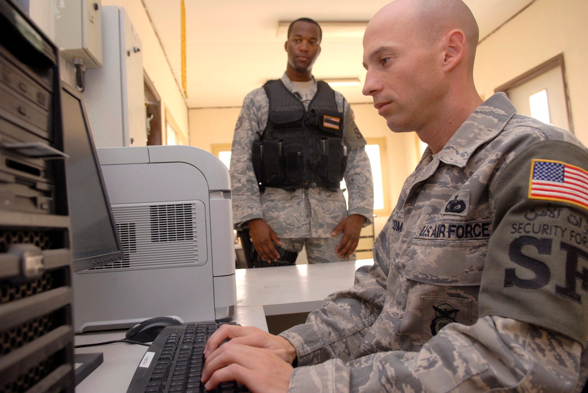 Staff Sgt. Fitzporter Kidd, 379th Expeditionary Security Force Squadron (ESFS) fire team leader and Tech. Sgt. William Newcomb, 379th ESFS Operations NCO, log in a statement for a report on an ID card that was turned in at the new substation, May 7, 2009, at an undisclosed location in Southwest Asia.  The Coalition Compound entry control point houses a new substation which aids security forces in expediting reports more efficiently.  Sergeant Kidd hails from Anniston, Ala. and is deployed from Columbus Air Force Base, Miss.  Sergeant Newcomb hails from Lancaster, S.C. and is deployed from Eglin Air Force Base, Fla.  Both are deployed in support of Operations Iraqi and Enduring Freedom and Combined Joint Task Force - Horn of Africa.  (U.S. Air Force photo/Senior Airman Andrew Satran/released)
