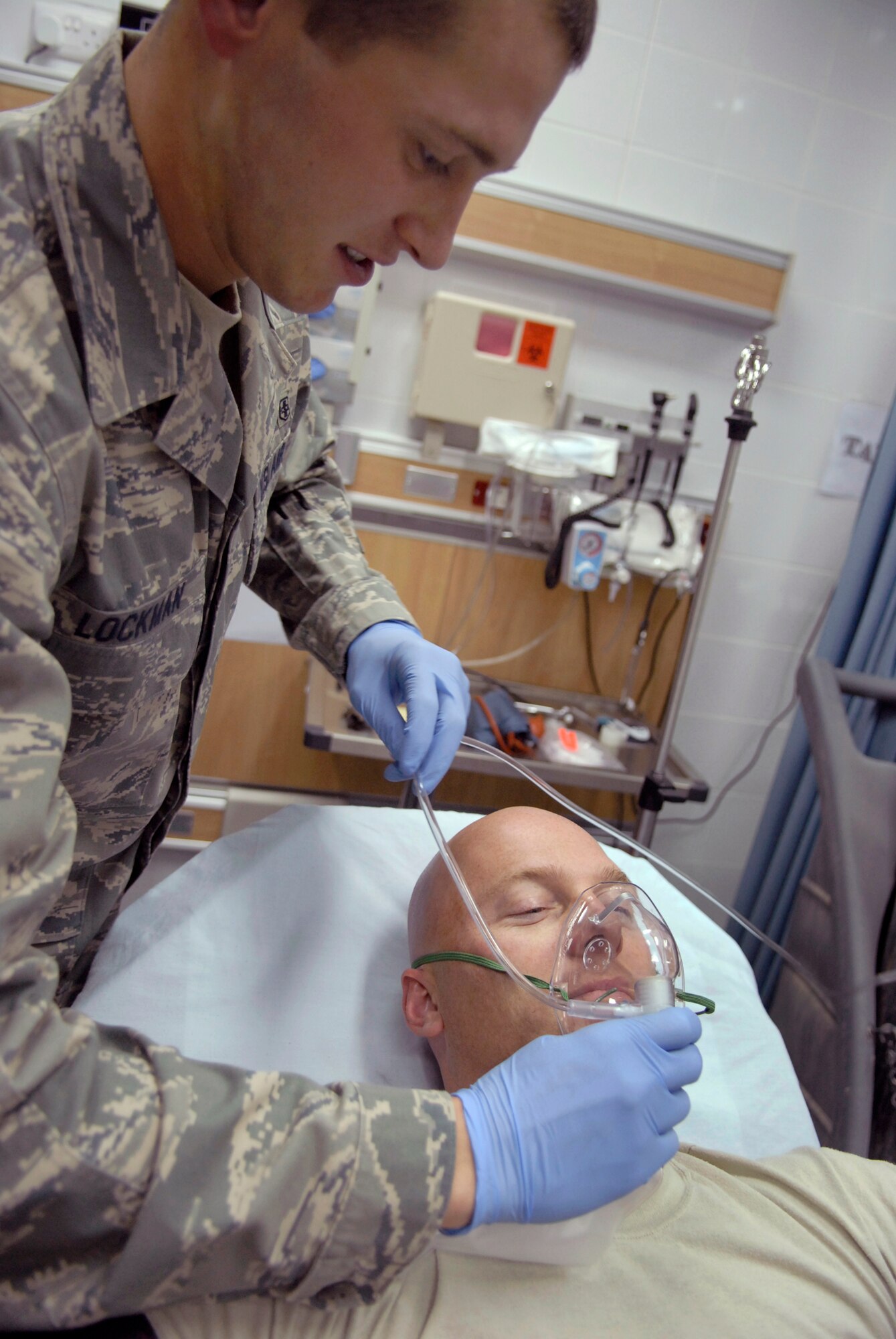 Senior Airman Joseph Lockman, a 379th Expeditionary Medical Group medical technician, puts a non-rebreather oxygen mask on a patient during emergency room patient care training, May 6, 2009, at an undisclosed location in Southwest Asia.  The med techs are first responders who provide basic medical care for patients by checking vitals and performing an initial assessment of their patients.  Airman Lockman hails from Canyonville, Oregon and is deployed from Keesler Air Force Base, Miss., in support of Operations Iraqi and Enduring Freedom and Combined Joint Task Force - Horn of Africa.  (U.S. Air Force photo/Senior Airman Andrew Satran/released)