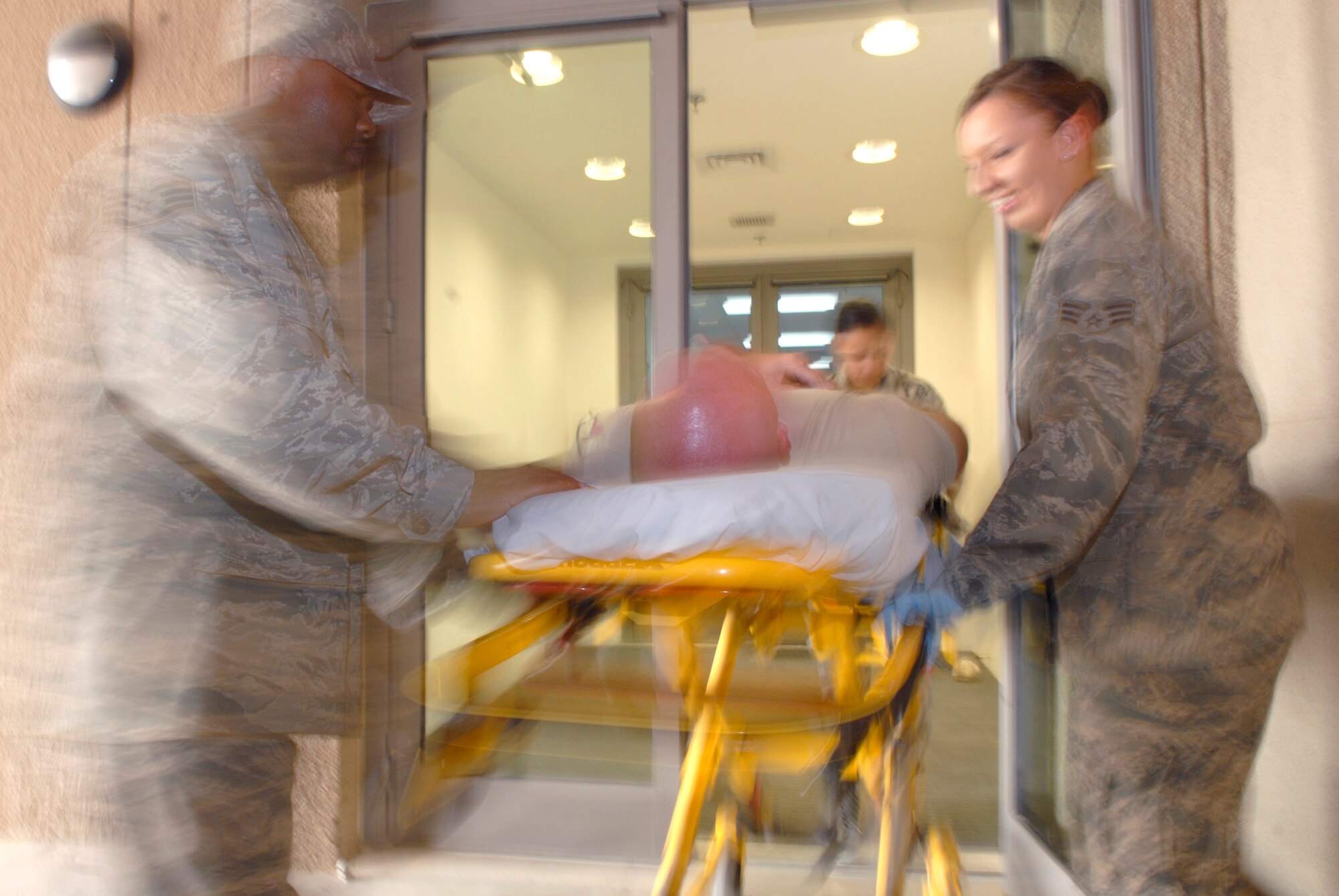 Staff Sgt. Javon Craig, Staff Sgt. Dalia Castillo, Senior Airman Ashley Ross, 379th Expeditionary Medical Group Medical Technicians (Med Techs), run through training on how to properly transport a patient from an ambulance to the emergency room using a gurney, May 6, 2009, at an undisclosed location in Southwest Asia.  The med techs are first responders who provide basic medical care for patients by checking vitals and performing an initial assessment of their patients.  Sergeant Castillo hails from Raymondville, Texas and is deployed from Travis Air Force Base, Calif.  Airman Ross hails from Herman, Maine and is deployed from Keesler Air Force Base, Miss.  Sergeant Craig hails from Newport News, Va. and is deployed from Keesler Air Force Base, Miss.  All are deployed in support of Operations Iraqi and Enduring Freedom and Combined Joint Task Force - Horn of Africa.  (U.S. Air Force photo/Senior Airman Andrew Satran/released/released)   