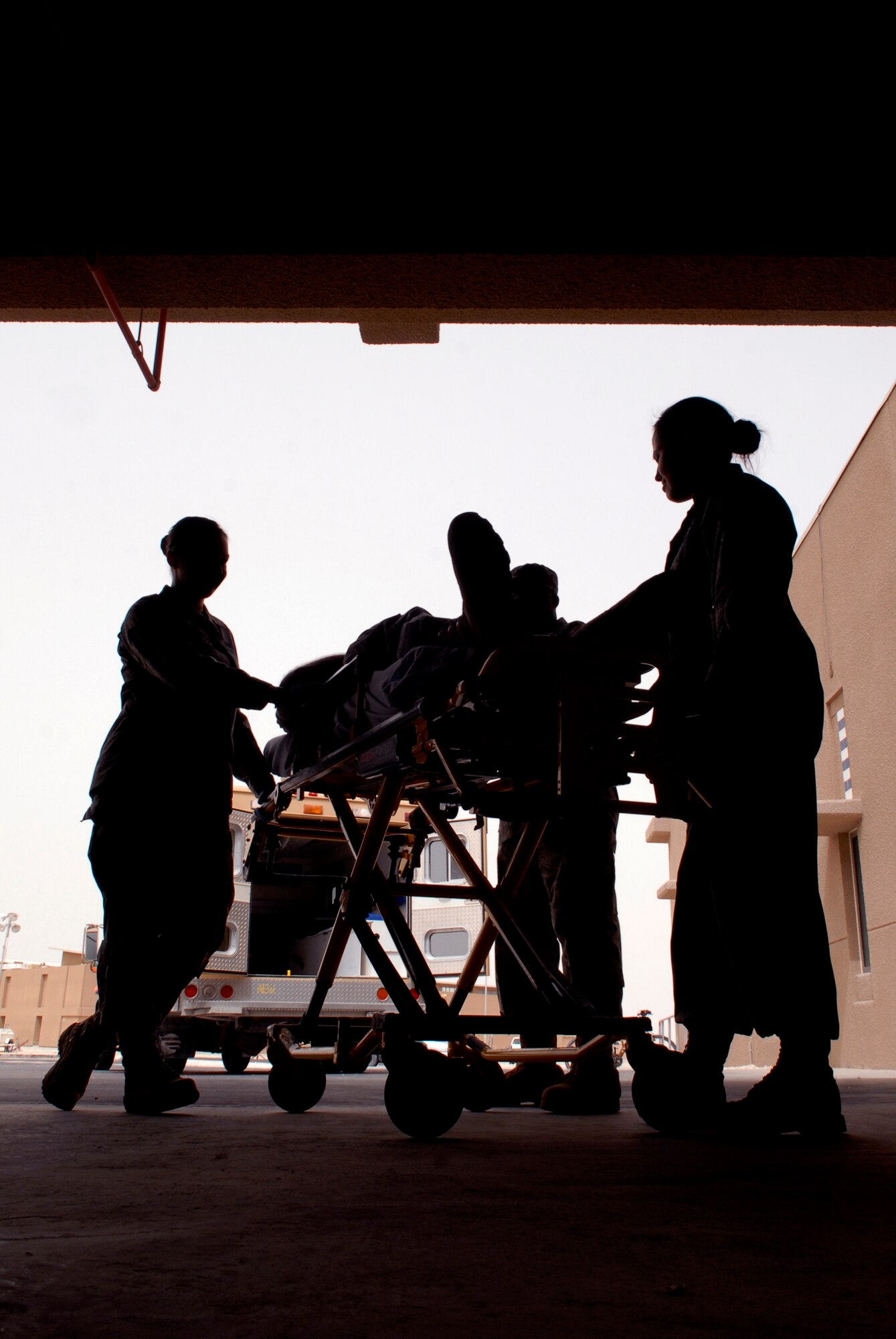 Staff Sgt. Javon Craig, Staff Sgt. Dalia Castillo, Senior Airman Ashley Ross, 379th Expeditionary Medical Group Medical Technicians (Med Techs), run through training on how to properly transport a patient from an ambulance to the emergency room using a gurney, May 6, 2009, at an undisclosed location in Southwest Asia.  The med techs are first responders who provide basic medical care for patients by checking vitals and performing an initial assessment of their patients.  Sergeant Castillo hails from Raymondville, Texas and is deployed from Travis Air Force Base, Calif.  Airman Ross hails from Herman, Maine and is deployed from Keesler Air Force Base, Miss.  Sergeant Craig hails from Newport News, Va. and is deployed from Keesler Air Force Base, Miss.  All are deployed in support of Operations Iraqi and Enduring Freedom and Combined Joint Task Force - Horn of Africa.  (U.S. Air Force photo/Senior Airman Andrew Satran/released/released)   