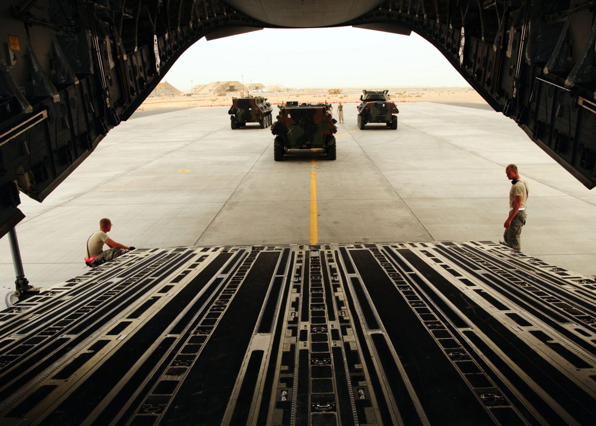SOUTHWEST ASIA -- Three United States Marine Corp Light Armored Vehicles are backed onto a C-17 Globemaster at an air base in Southwest Asia, May 6. The 386th Air Expeditionary Wing is assisting the 2nd Marine Expeditionary Brigade with moving their supplies into Afghanistan. (U.S. Air Force photo/ Senior Airman Courtney Richardson)