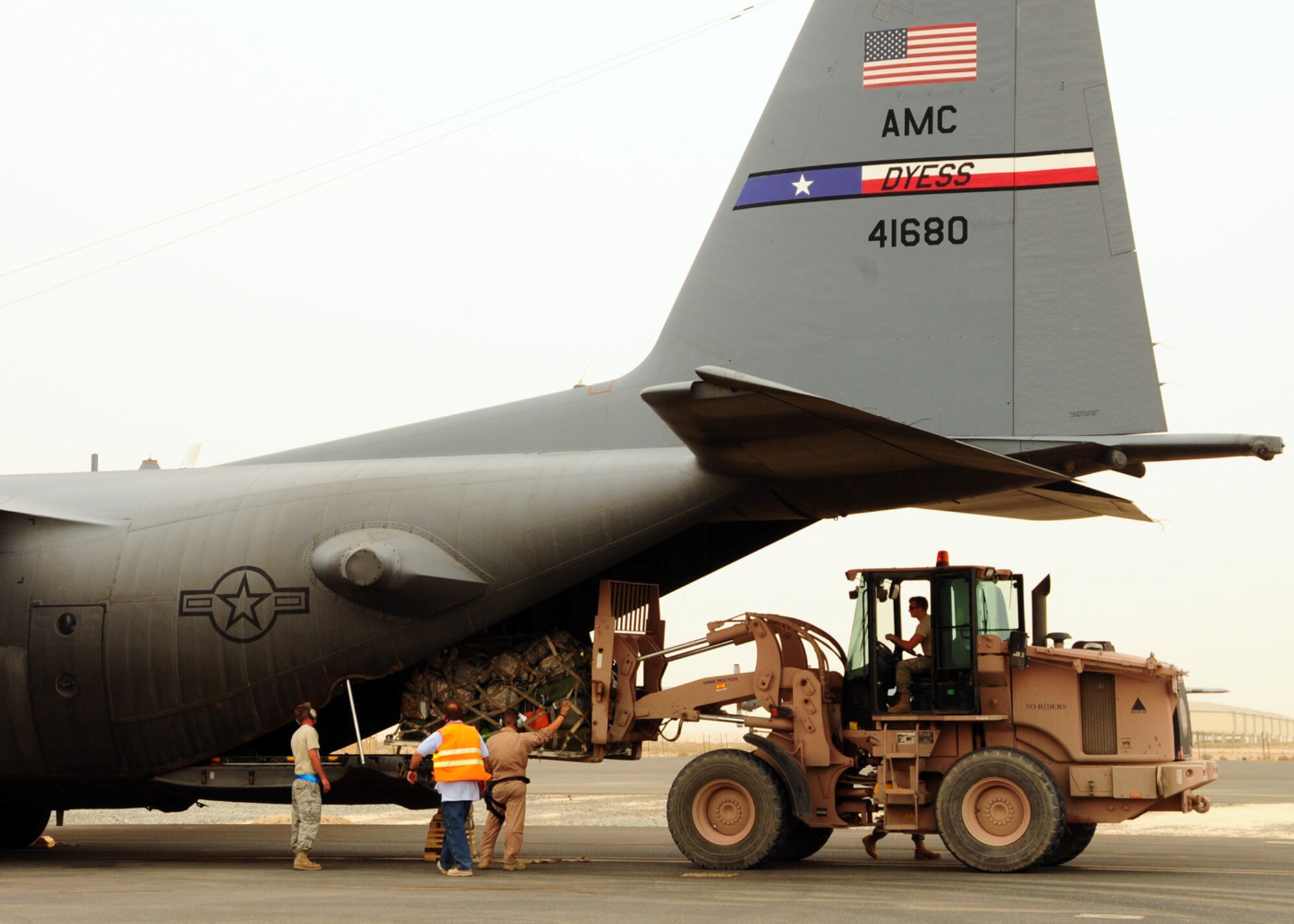 SOUTHWEST ASIA -- Airmen from the 386th Expeditionary Logistics Readiness Squadron unload cargo from a C-130 Hercules at an air base in Southwest Asia, May 6. At any given time an aircraft can carry personnel and supplies at the same time to bases throughout the area of responsibility. (U.S. Air Force photo/ Senior Airman Courtney Richardson)