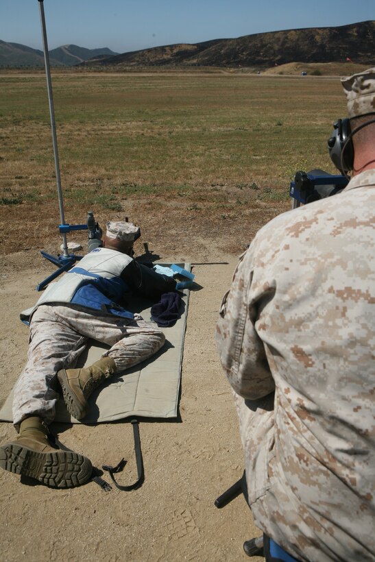 Master Sgt. James D. Wagner, a rifle member for Marine Corps Air Station's Miramar Shooting Team shoots from the 500 yard prone, during the Team Rifle Matches, May 7. Sgt. Randy J. Sayers, coach of the team tells Wagner the proper adjustments to hit the target on the black.