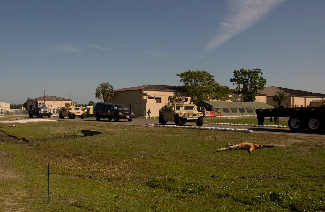 A 125th Fighter Wing convoy passes a simulated deceased insurgent after a staged attack during an Operational Readiness Inspection Phase II,  125th Fighter Wing, Jacksonville, Florida, May 8, 2009.  The ORI Phase II analyzes the unit's ability to fight and survive from a deployed base. (Air National Guard Photo by Master Sgt. Larry Show)