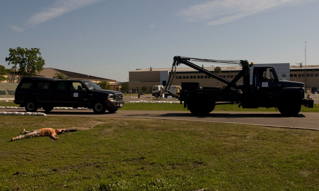 A 125th Fighter Wing convoy passes a simulated deceased insurgent after a staged attack.. The simulated attack took place during an Operational Readiness Inspection Phase II at the 125th Fighter Wing, Jacksonville, Florida, May 8, 2009.  The ORI Phase II analyzes the unit's ability to fight and survive from a deployed base. (Air National Guard Photo by Master Sgt. Larry Show)