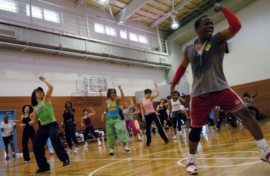 YOKOTA AIR BASE, Japan -- Lloyd Mangaroo leads a workout session during Yokota's Latin American Club first-ever Zumbathon May 9 at the Samurai Fitness Center. More than 75 people worked out during the three-hour Zumba session. Zumba, which combines Latin music and dance with easy to follow moves, is currently one of the fastest growing fitness programs in the world. Zumba classes are offered from 5-6 a.m. Wednesdays and 9-10 a.m. Saturdays at the fitness center annex. (U.S. Air Force photo/Master Sgt. Matt Summers)