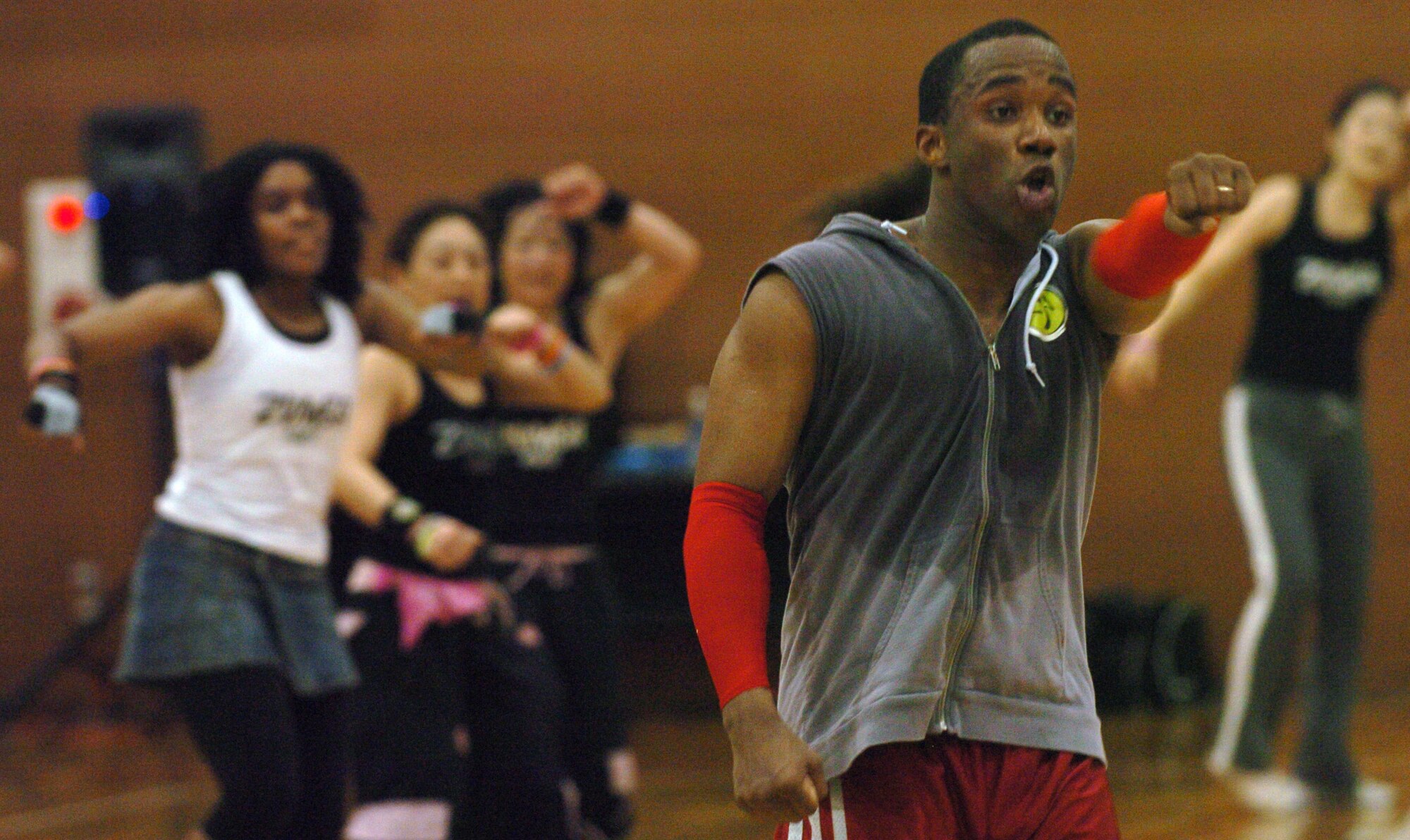 YOKOTA AIR BASE, Japan -- Lloyd Mangaroo leads a workout session during Yokota's Latin American Club first-ever Zumbathon May 9 at the Samurai Fitness Center. More than 75 people worked out during the three-hour Zumba session. Zumba, which combines Latin music and dance with easy to follow moves, is currently one of the fastest growing fitness programs in the world. Zumba classes are offered from 5-6 a.m. Wednesdays and 9-10 a.m. Saturdays at the fitness center annex. (U.S. Air Force photo/Master Sgt. Matt Summers)