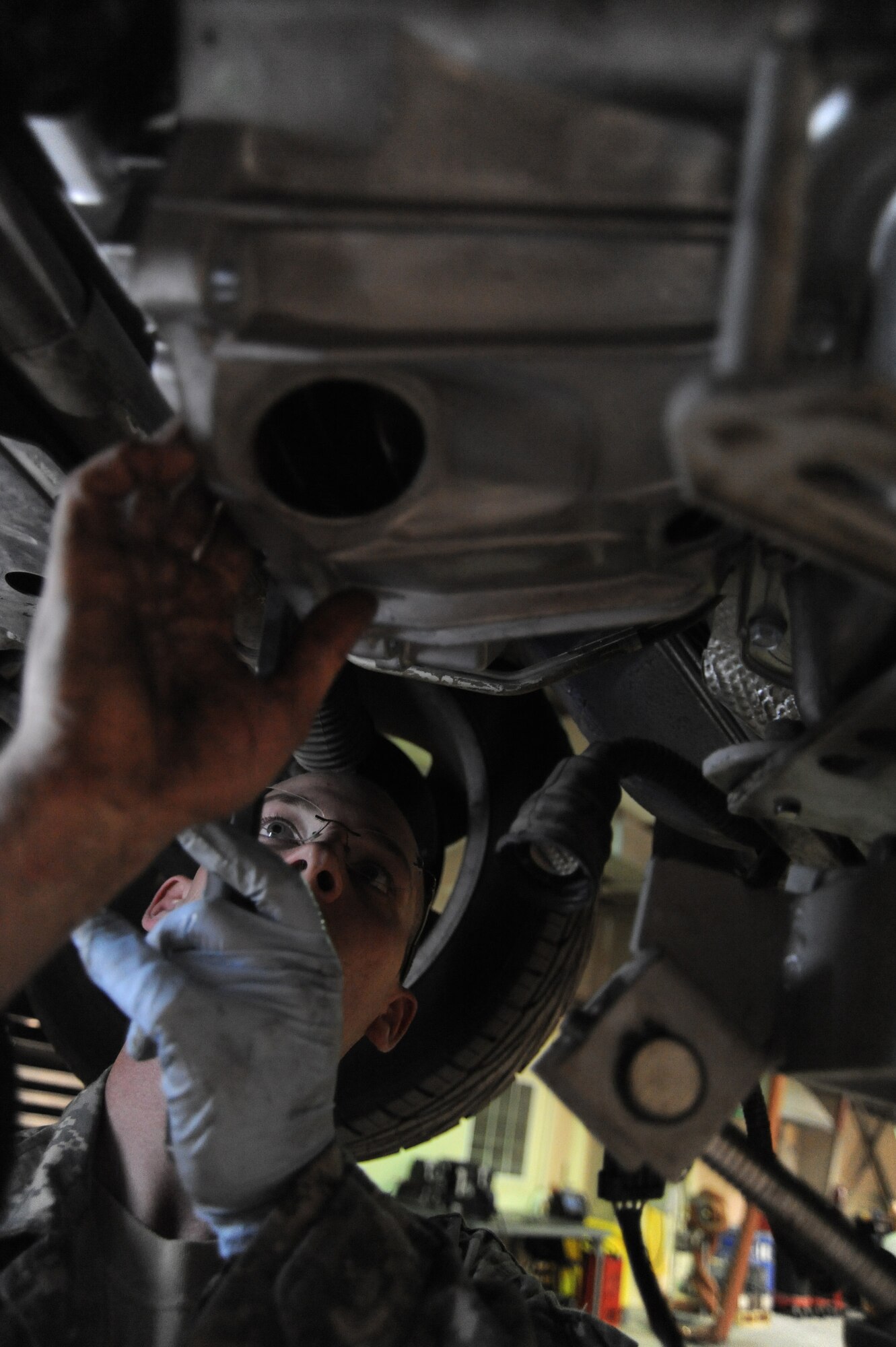 Senior Airman Adam Owens, 380th Expeditionary Logistics Readiness Squadron, vehicle maintenance, lines-up the fly wheel on a Pontiac GTO with the torque converter of a new transmission, April 26 at an undisclosed location in Southwest Asia. The GTO is used as a chase car to help guide the U-2 Dragon Lady pilots during take-offs and landings. Airman Owens is deployed from 174th Air National Guard Base, Hancock Field, N.Y. and hails from Binghamton, N.Y. (U.S. Air Force photo by Senior Airman Brian J. Ellis) (Released)