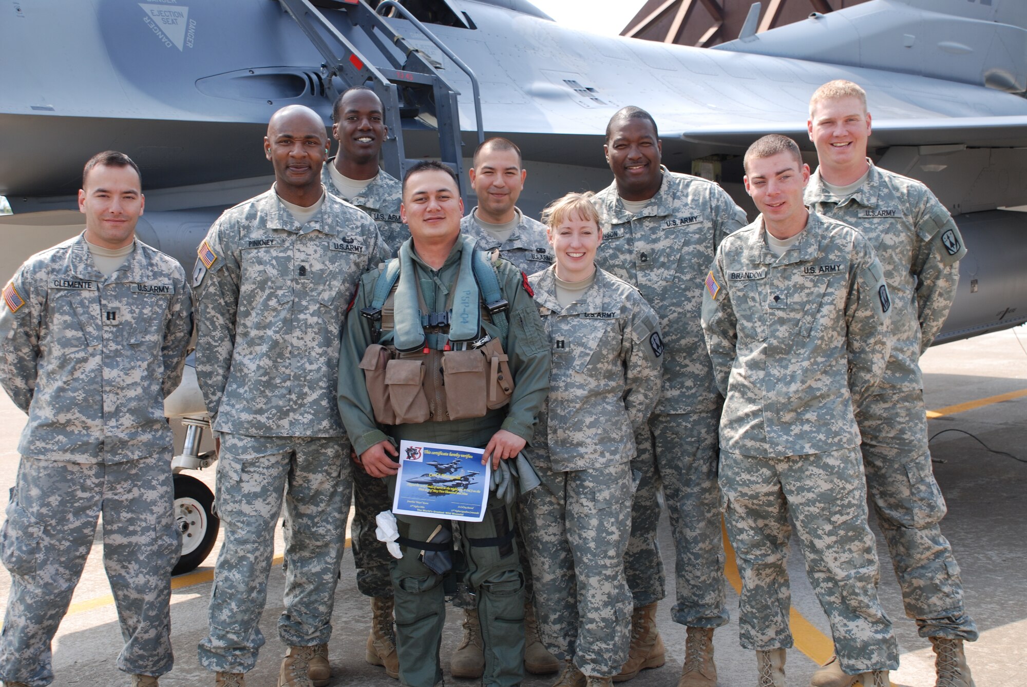 Army SGT Carl Matagolai, 3-2 Arial Defense Artillery D-32, poses with his leadership following an Air Force F-16D incentive flight in a 13th Expeditionary Fighter Squadron (deployed).  SGT Matagolai was rewarded with a first-ever joint incentive flight at Suwon AB, ROK after being named 3-2 ADA Battalion NCO of the Quarter.  The 13th EFS is deployed to Suwon from the 35 FW, Misawa AB, Japan. (USAF Photo/MSgt Lynn Rooker)
