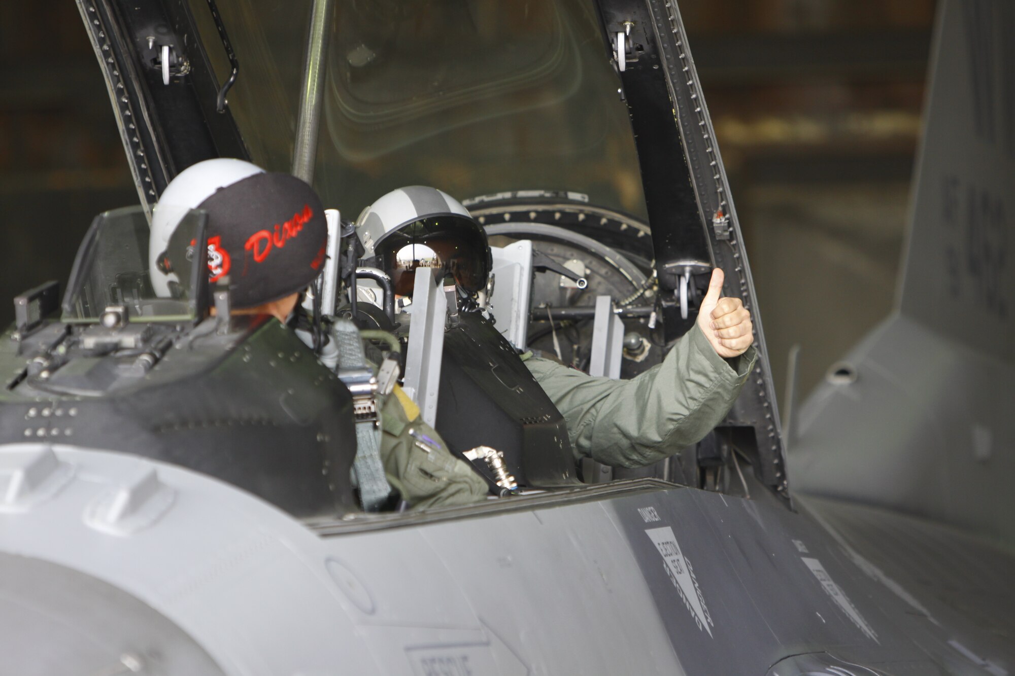 Army SGT Carl Matagolai, 3-2 Arial Defense
Artillery D-32, gives the thumbs up before the canopy closes and Air Force
pilot, Capt Jonathan Kuntz, 13th Expeditionary Fighter Squadron (deployed),
Suwon AB, ROK completes his pre-flight checks. SGT Matagolai was rewarded
with an F-16D incentive flight after being named 3-2 ADA Battalion NCO of
the Quarter.  His flight marks a first-ever joint incentive flight for the
13th EFS. (USAF Photo/SMSgt Wayne Cardwell)

