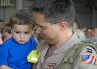 HURLBURT FIELD, Fla. -- Captain Randy Martin, 711th Special Operations Squadron, gets reacquainted with son Alexander, 2, moments after he and more than two dozen of his fellow 919th Special Operations Wing reservists returned May 7 from their deployment in support of Operation Enduring Freedom.  Airmen from Duke Field's 919th SOW are in the midst of a busy season of deployed combat support for the ongoing overseas contingency operation.  (U.S. Air Force photo/Dan Neely)