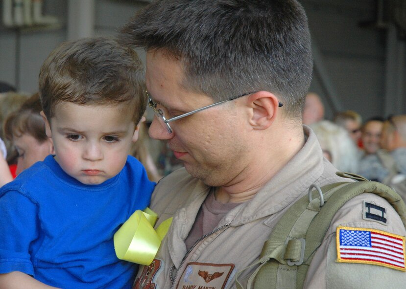 HURLBURT FIELD, Fla. -- Captain Randy Martin, 711th Special Operations Squadron, gets reacquainted with son Alexander, 2, moments after he and more than two dozen of his fellow 919th Special Operations Wing reservists returned May 7 from their deployment in support of Operation Enduring Freedom.  Airmen from Duke Field's 919th SOW are in the midst of a busy season of deployed combat support for the ongoing overseas contingency operation.  (U.S. Air Force photo/Dan Neely)