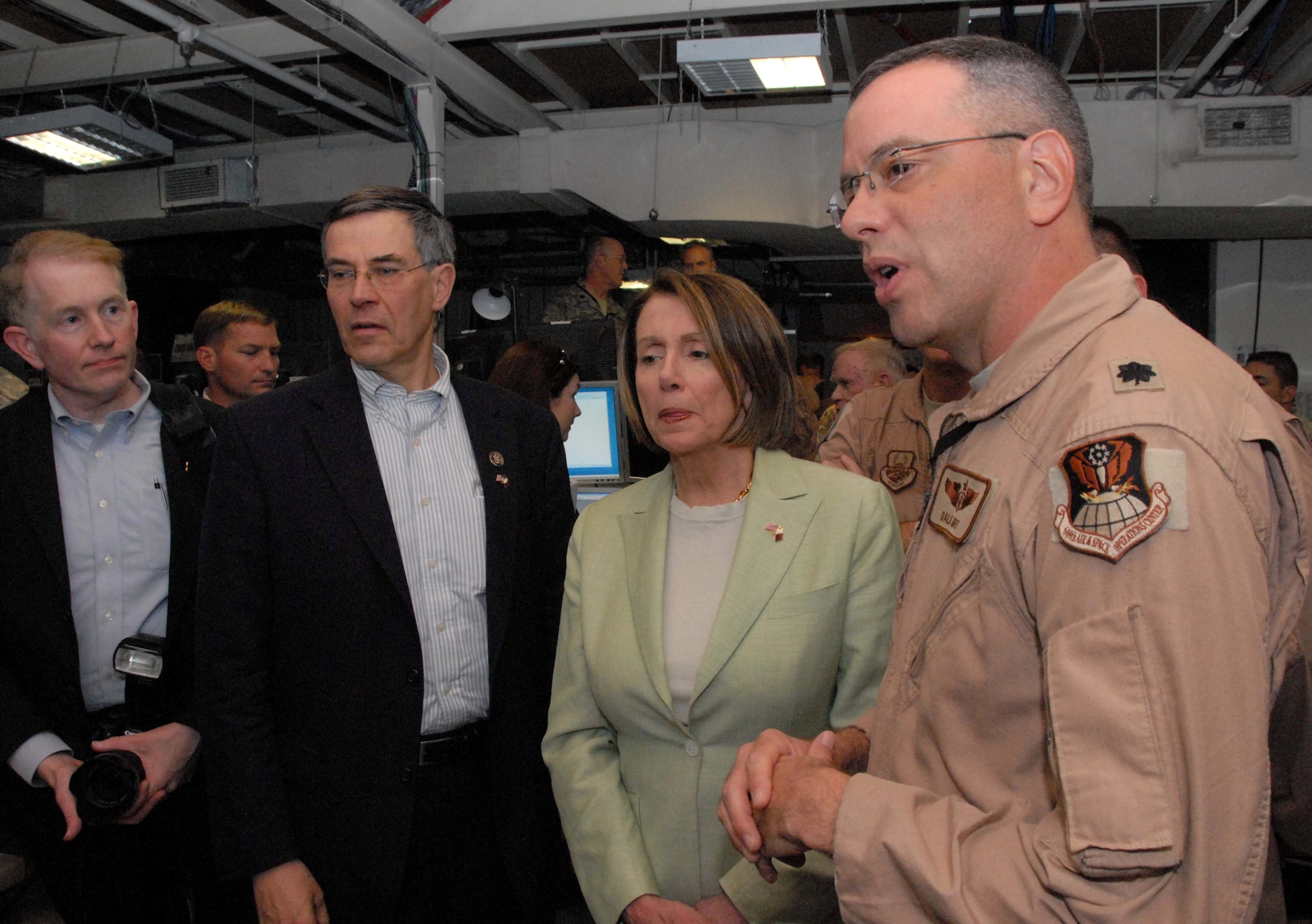 SOUTHWEST ASIA -- Lt. Col. Dale Grey, Air Evacuation Control Team Chief, briefs U.S. House of Representatives Speaker Nancy Pelosi (D-Calif.) and U.S. Representative Rush Holt (D-N.J.) during a visit to the Combined Air and Space Operations Center May 8, 2009, at an undisclosed location in Southwest Asia. Colonel Grey is deployed from Scott Air Force Base, Ill., and hails from Norwich, N.Y. (U.S. Air Force photo by Chief Master Sgt. Lemuel Casillas)