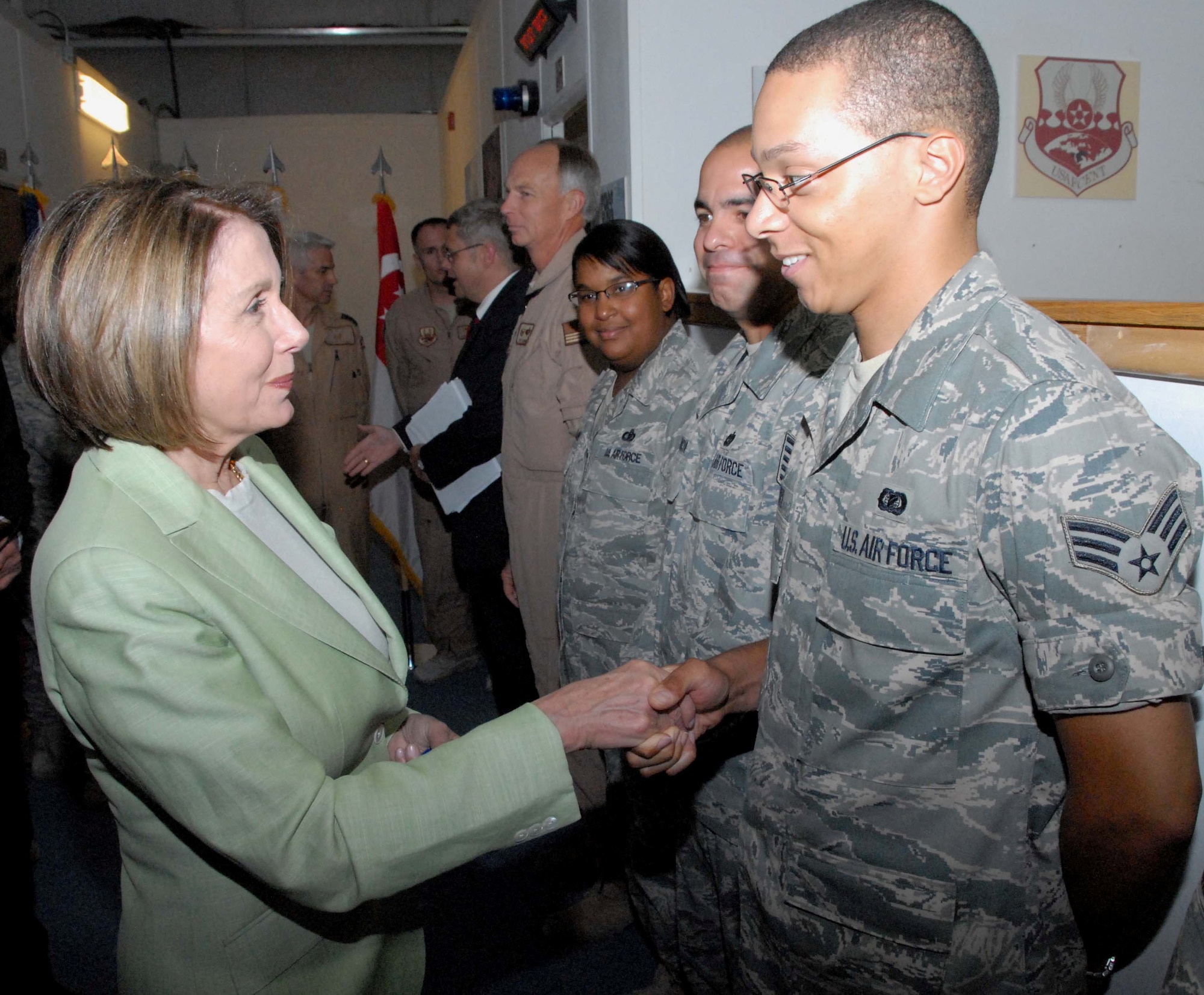 SOUTHWEST ASIA -- Speaker of the U.S. House of Representatives Nancy Pelosi (D-Calif.) greets Senior Airman Daniel Moore, Deputy Combined Force Air Component Commander knowledge information manager, during a visit to the Combined Air and Space Operations Center May 8, 2009, at an undisclosed location in Southwest Asia. Airman Moore is deployed from Edwards Air Force Base, Calif., and hails from Detroit.  (U.S. Air Force photo by Chief Master Sgt. Lemuel Casillas)