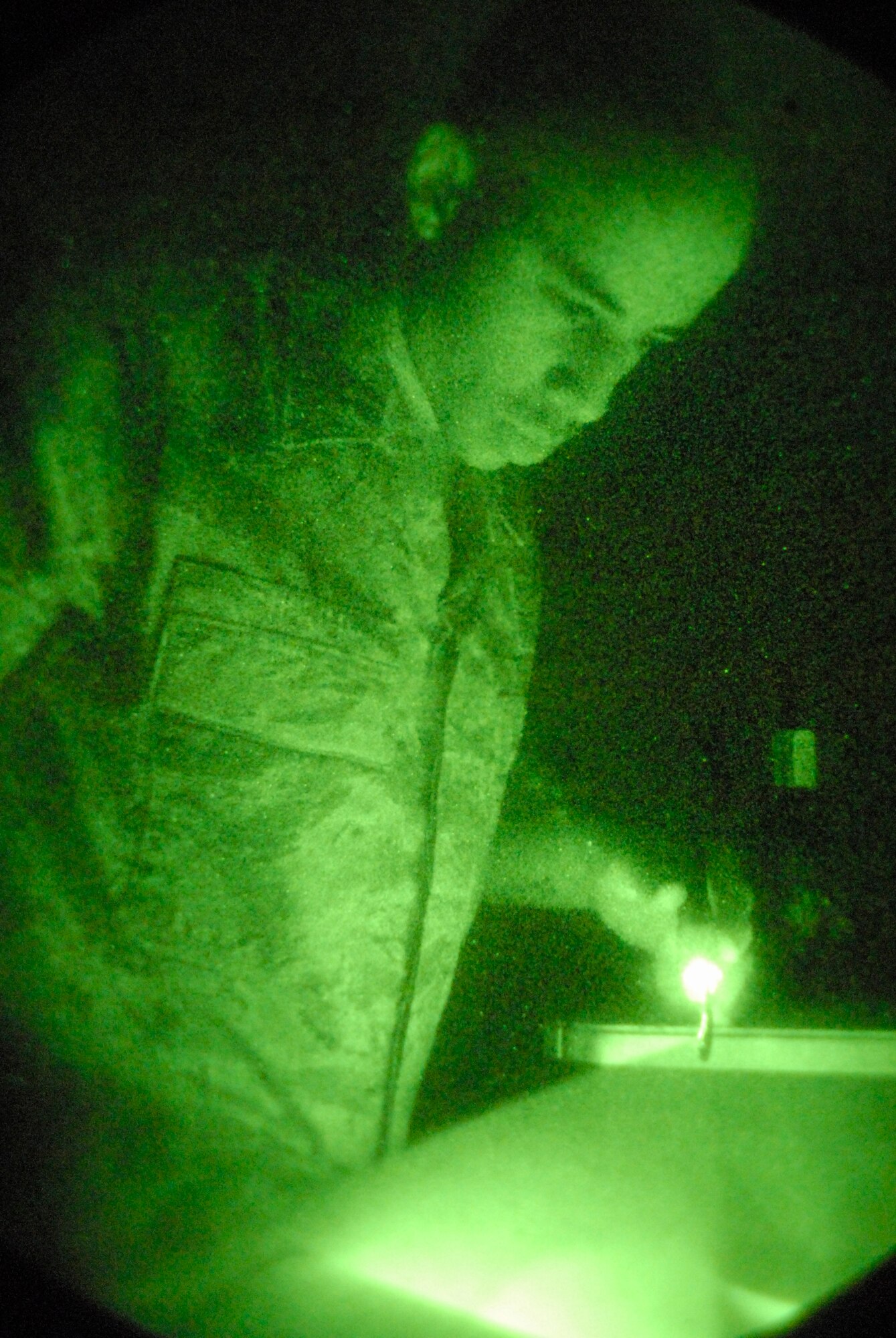 Staff Sgt. Ronnie Hester, an aircrew flight equipment technician assigned to the 8th Operations Support Squadron, checks a technical order while performing an operations check on a pair of night vision goggles at Kunsan Air Base, Republic of Korea. Aircrew flight equipment technicians are responsible for all of the equipment that will save a pilot's life in the event the pilot has to eject from the aircraft. (U.S. Air Force Photo by Staff Sgt Jason Colbert)


