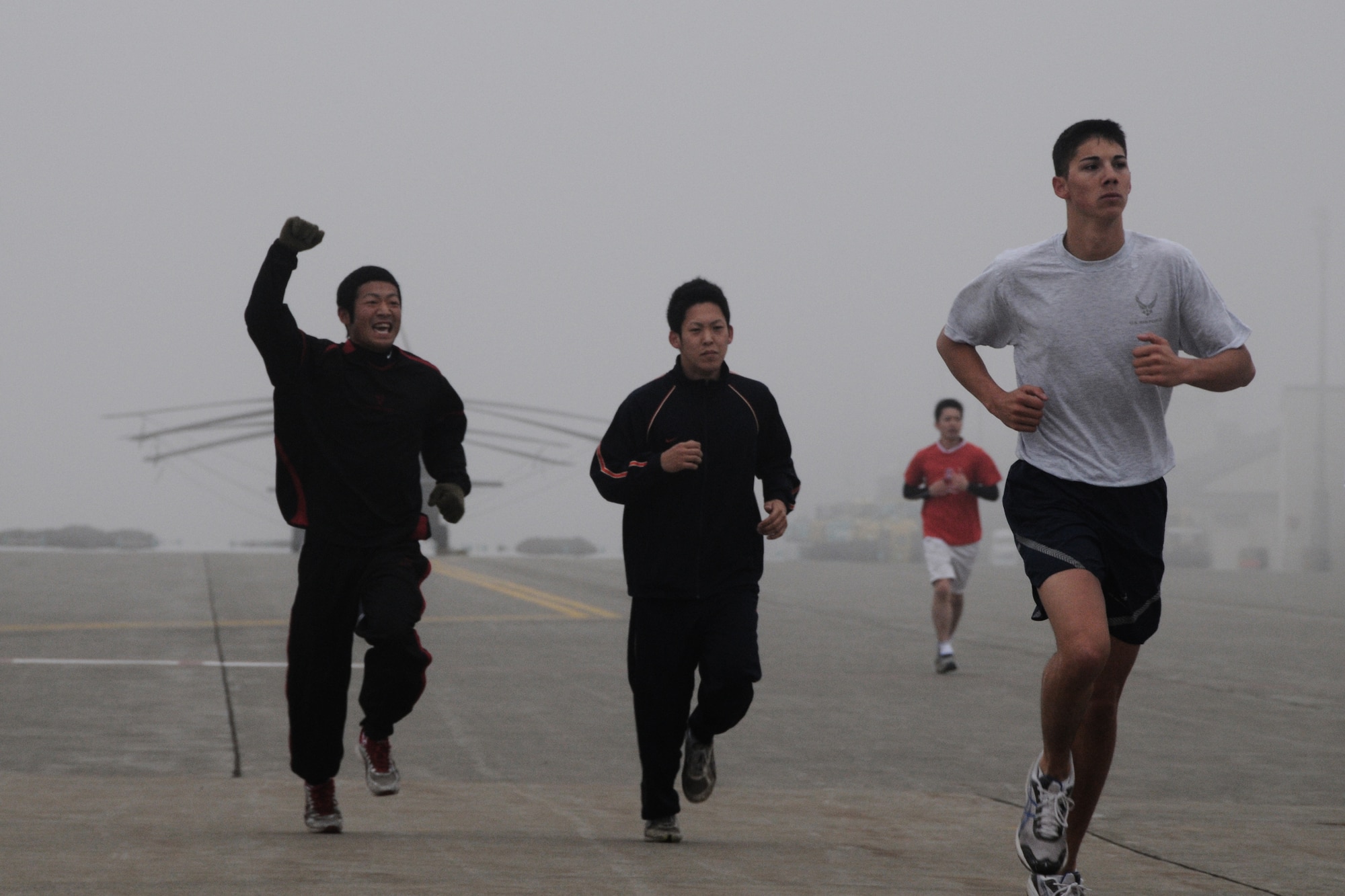 MISAWA AIR BASE, Japan -- A member of the Japan Air Self-Defense Force shows his enthusiasm during a readiness run with fellow JASDF members, Airmen, Soldiers and Sailors May 8, 2009. Readiness runs are held six months of the year to build unit morale and encourage fitness. (U.S. Air Force photo by Senior Airman Jamal Sutter)