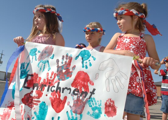 Kindergartener students from the Child Development Center's enrichment class carry a "Hands on Learning" poster during the Military Child Parade at Holloman Air Force Base, N.M., April 30. Handprints of each student were painted red, white and blue for this year's annual parade. (U.S. Air Force photo/Airman 1st Class Veronica Stamps) 