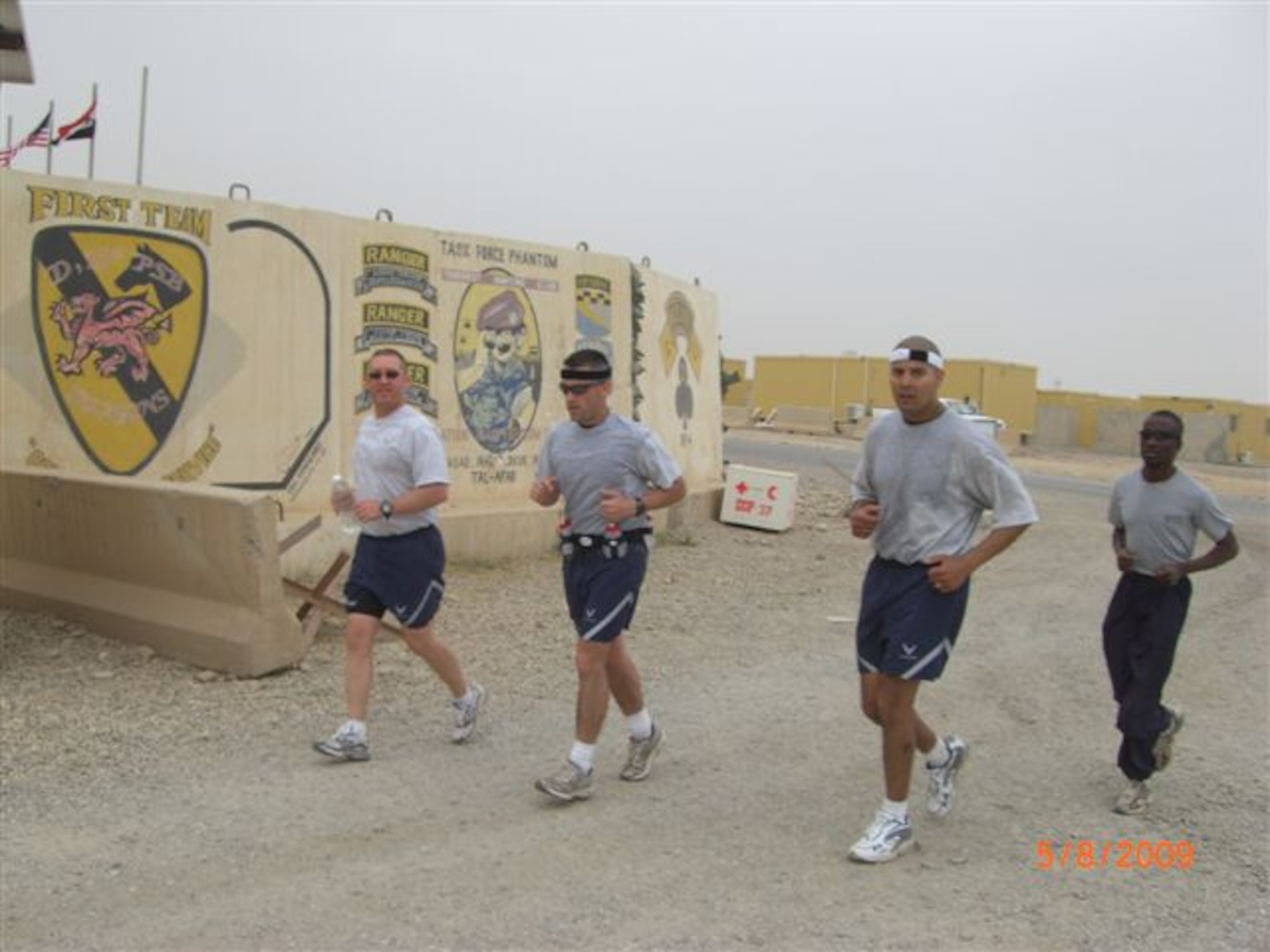 (left to right) Tech. Sgt. Todd P. Seguin and Tech. Sgt. Sam A. Ruiz, both of the 119th Wing Security Forces Squadron, Staff Sgt. Sonny Hernandez, of the 445th Security Forces Squadron and Kavuma Richard, a contractor from Uganda, Africa, participate in the Fargo Marathon from Iraq on May 9.