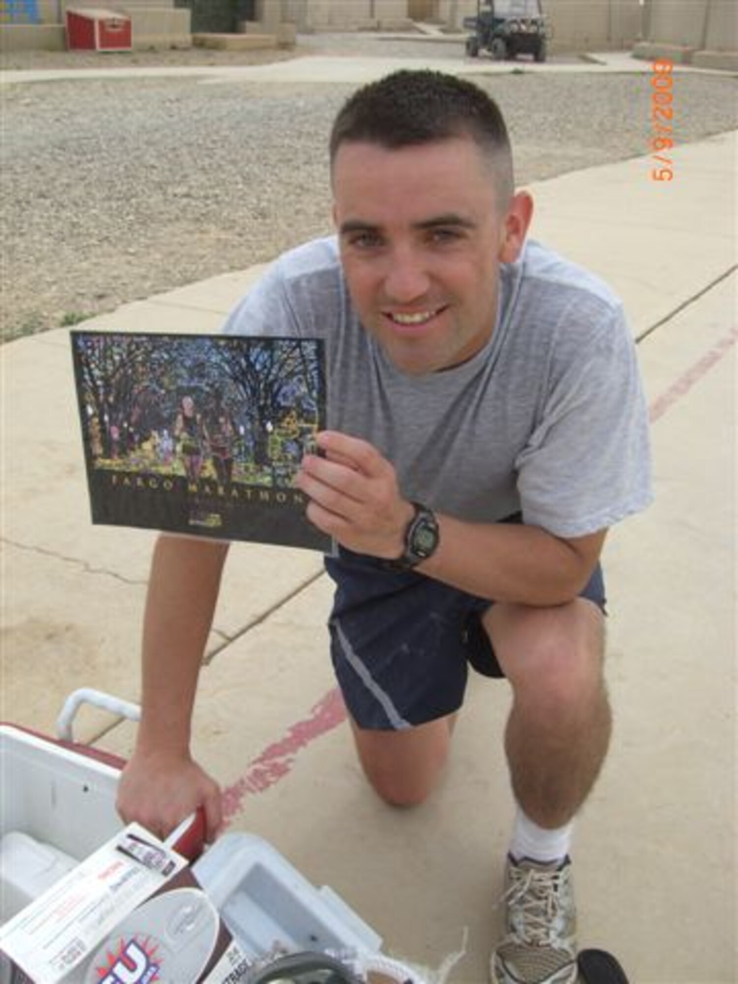 Tech. Sgt. Sam A. Ruiz of the 119th Wing Security Forces Squadron, North Dakota Air National Guard, holds a Fargo Marathon picture after completing the Fargo Marathon from Iraq on May 9.