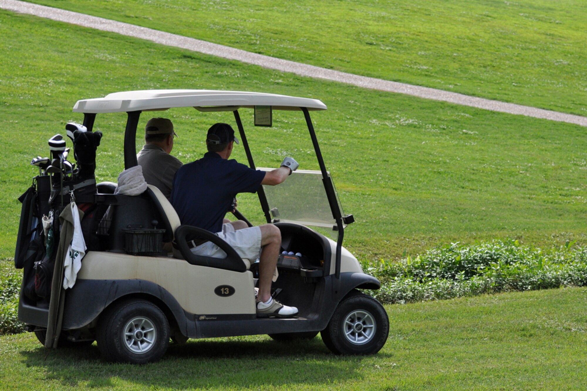 Two, for the most part, unidentified golfers try to locate a lost ball during the 917th Wing’s Commander’s Cup Golf Tournament at the Fox Run Golf Course on Barksdale Air Force Base, La., May 2, 2009. One gentleman works at the 47th Fighter Squadron and the other for the 917th Maintenance Operations Squadron at Barksdale. The golf tournament is an annual event in conjunction with the 917th Wing’s Family Day celebration. (US Air Force photo/Tech. Sgt. Jeff Walston)