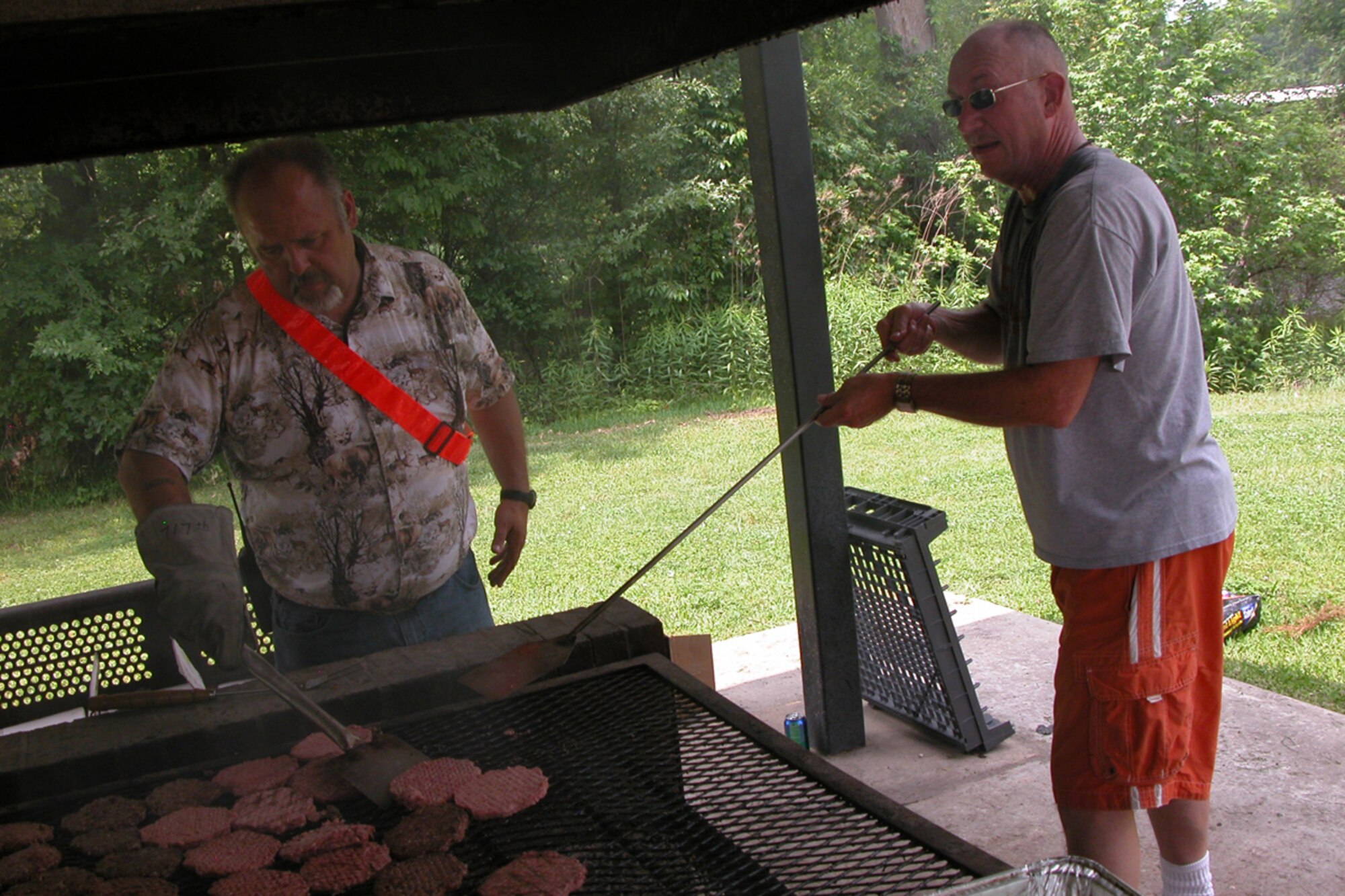 Harry  Bauer and Harold Starkey take on the grill during the 917th Wing’s Family Day celebration at Barksdale Air Force Base, La., May 2, 2009. Both gentlemen work for the 917th Wing at Barksdale. The Family Day celebration is an annual event in conjunction with a golf tournament at the Fox Run Golf Course. (US Air Force photo/Betty Stephens)