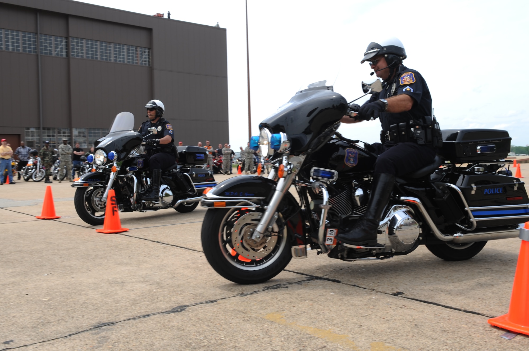 LANGLEY AIR FORCE BASE, Va. -- Dan Pryor and Eddie Gause, Hampton Police Motor Unit master police officers, participate in a race during the slow drag portion of the annual motorcycle safety day here May 8. This annual event is a command directed event for the 101 Critical Days of Summer that ensures motorcyclists practice the rules of the road. (U.S. Air Force photo/Senior Airman Ashley Hawkins)