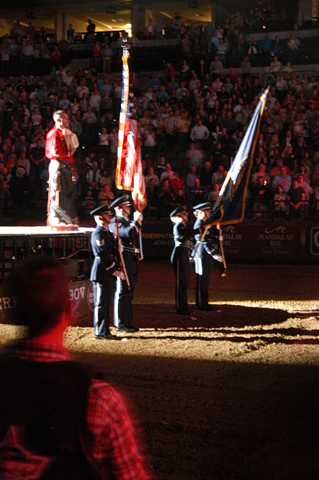 Members of the Offutt Air Force Base Honor Guard present the American Flag and State of Nebraska flag during the opening ceremonies of the Professional Bull Riders Association event April 24, at the Quest Center in Omaha, Neb. (U.S. Air Force photo/Tech. Sgt. David McCarrison)